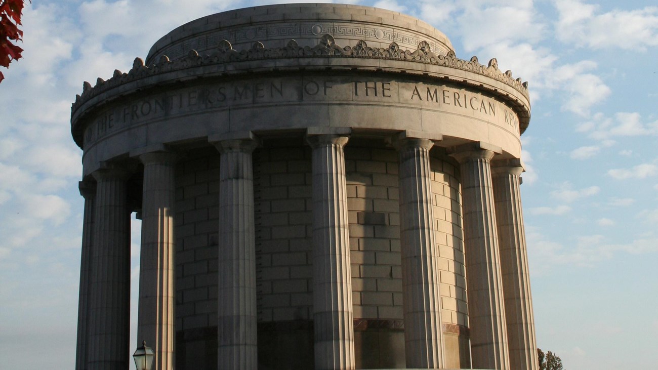 stone memorial with columns and leaves over top