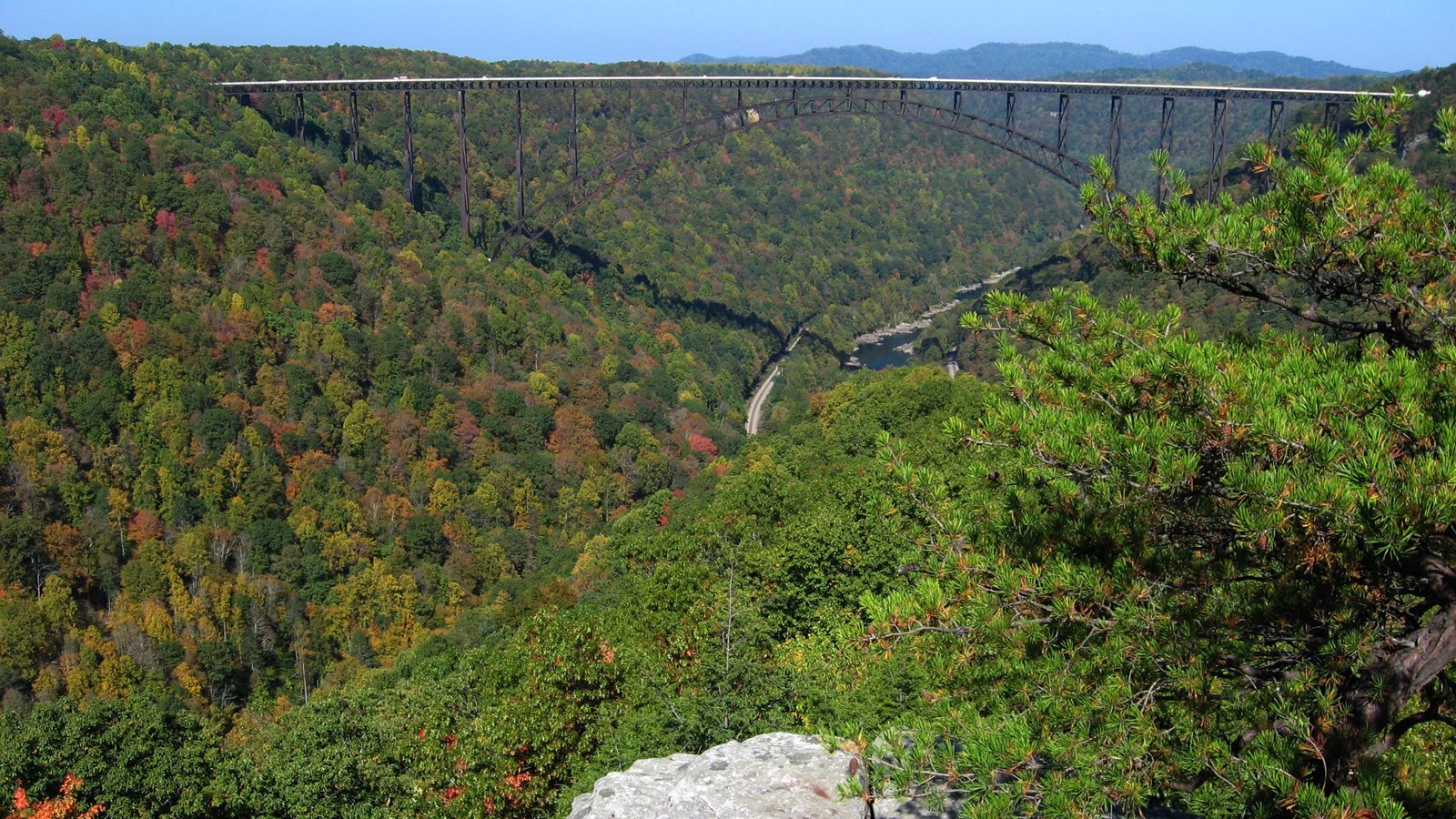 A view of the New River Gorge Bridge spanning river and deep gorge