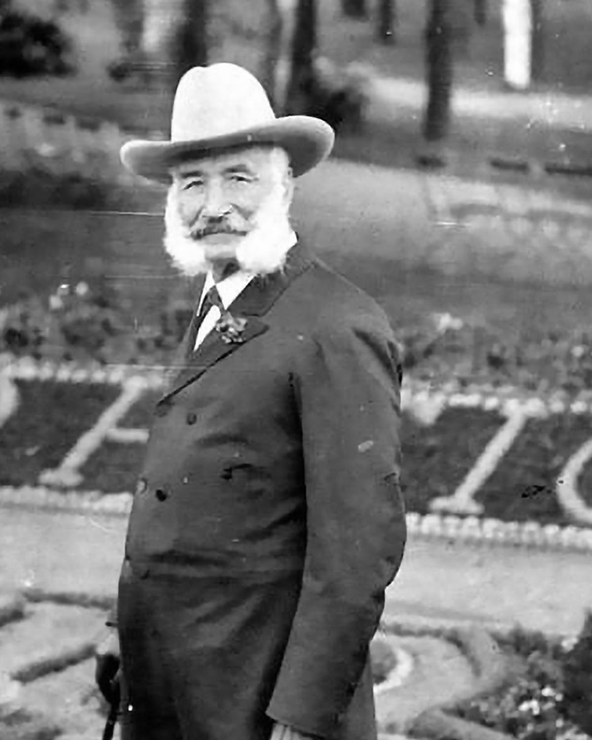 Man poses outside in a suit