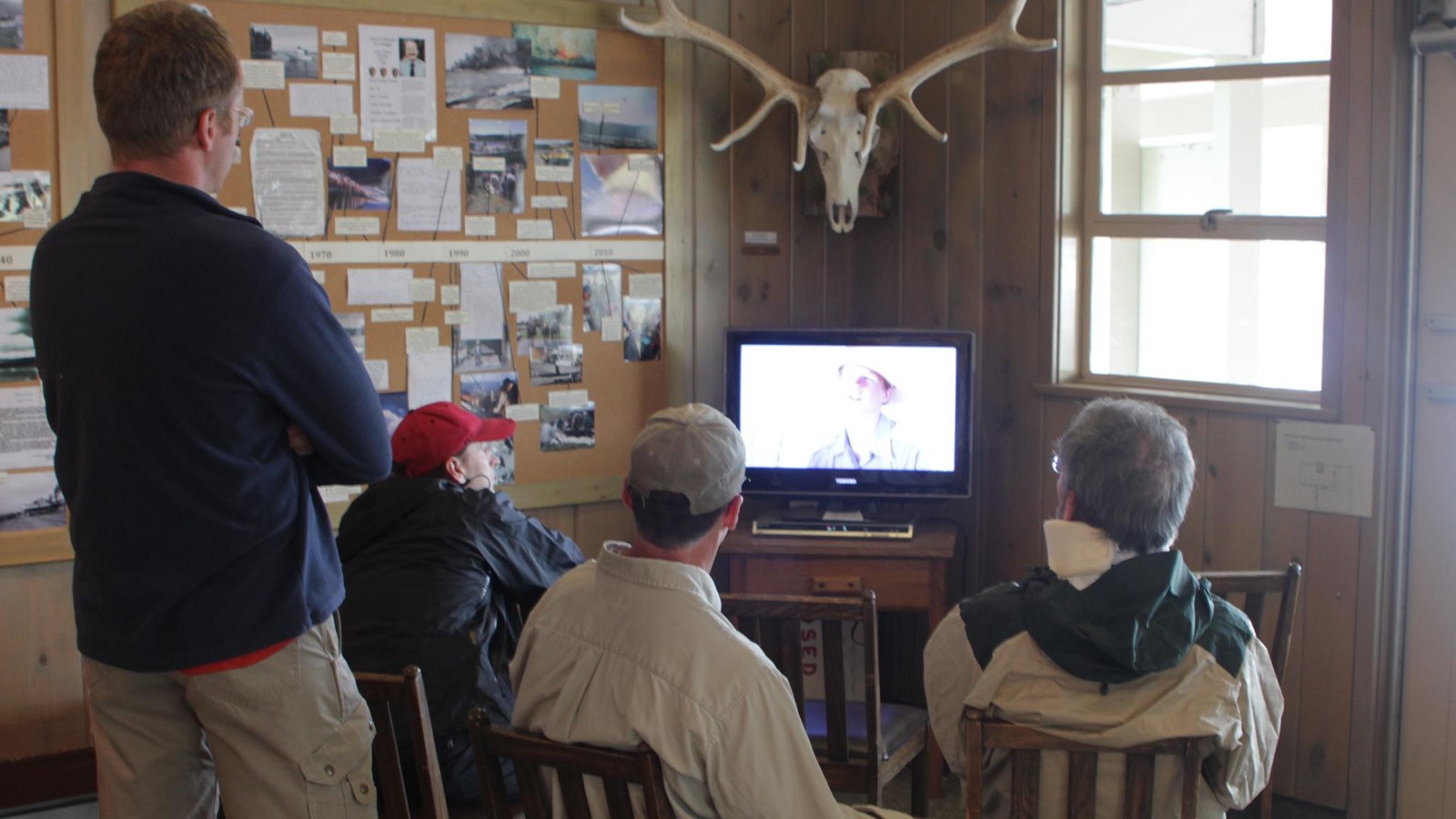 visitors watching backcountry video at a ranger station