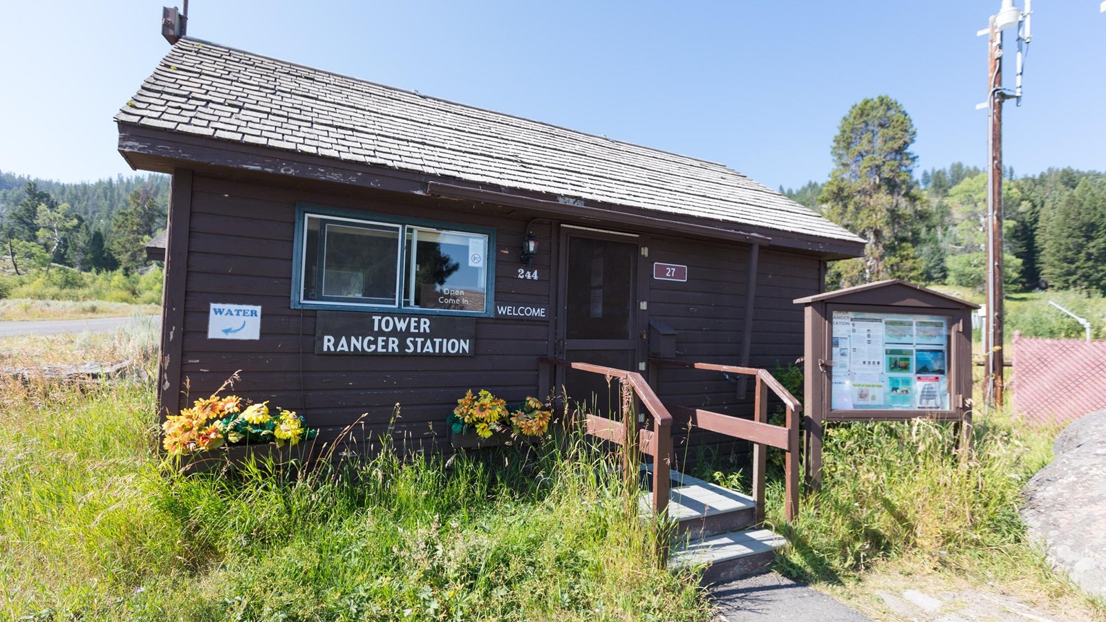 Small wood-framed building with sign on the front that reads Tower Ranger Station