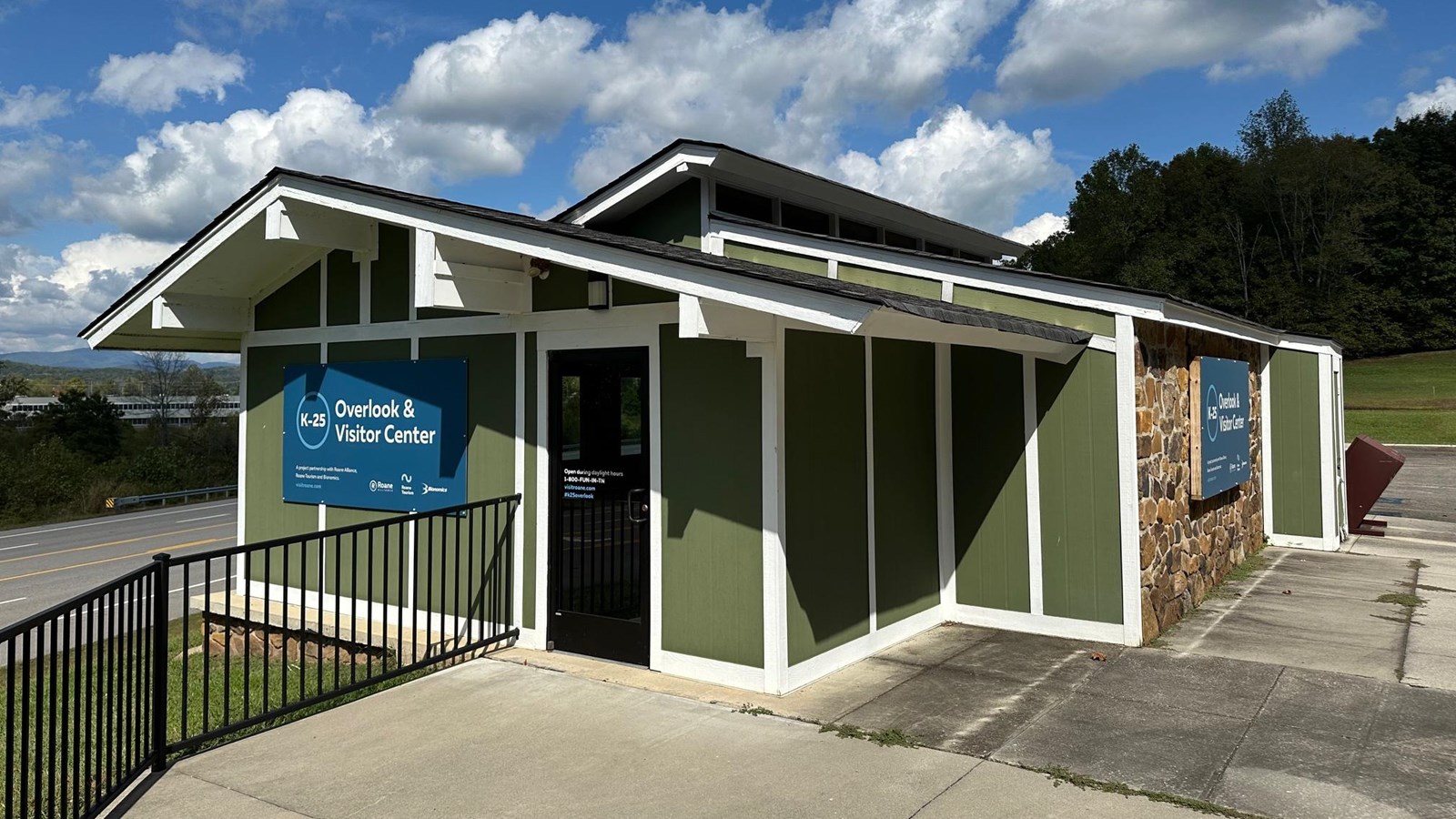 A small one-story visitor center sits on an elevated parking lot.