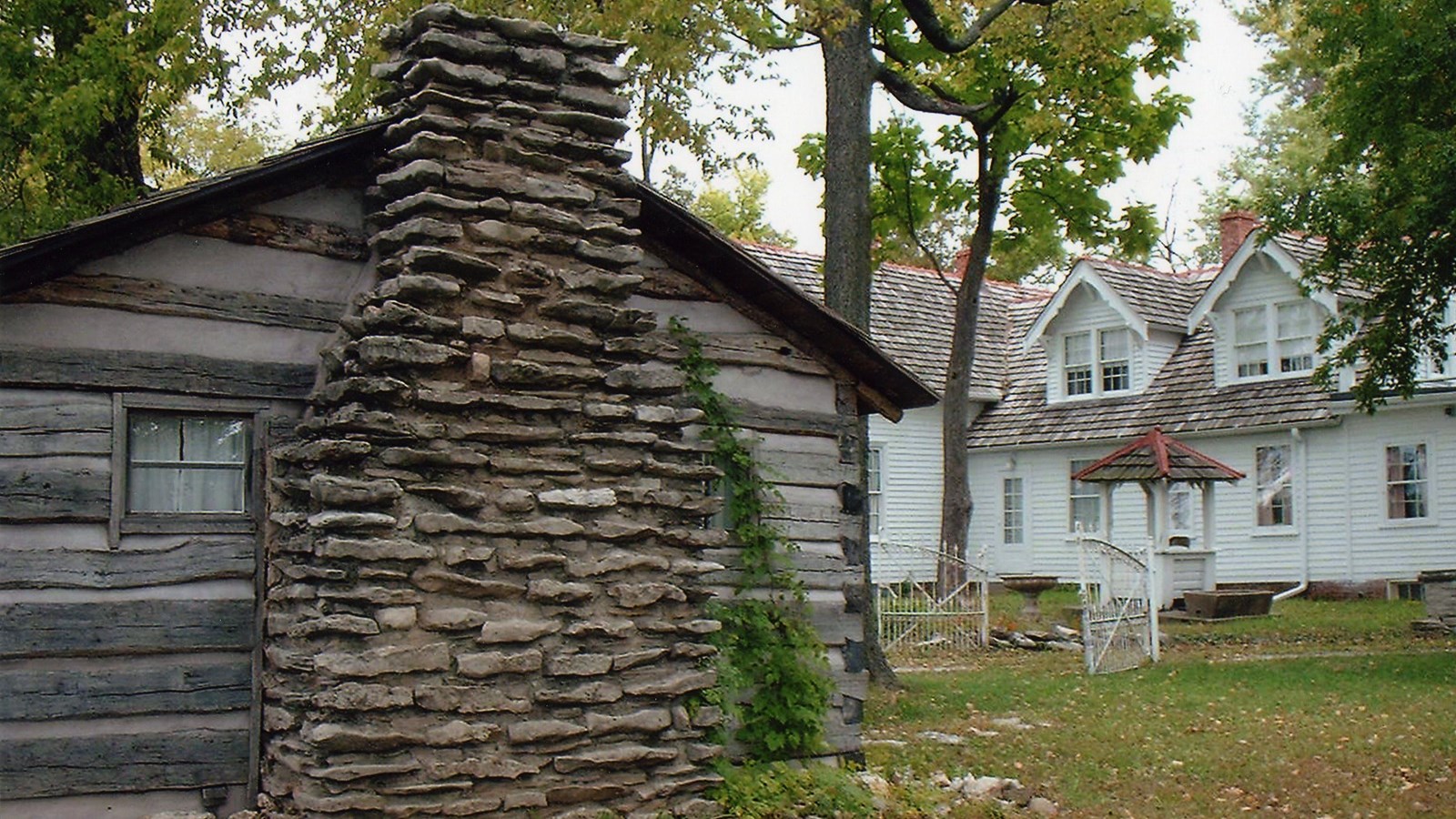 A large, white, gothic revival historic home.