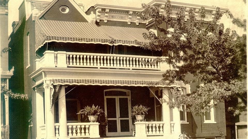 two-story house with front porch and balcony