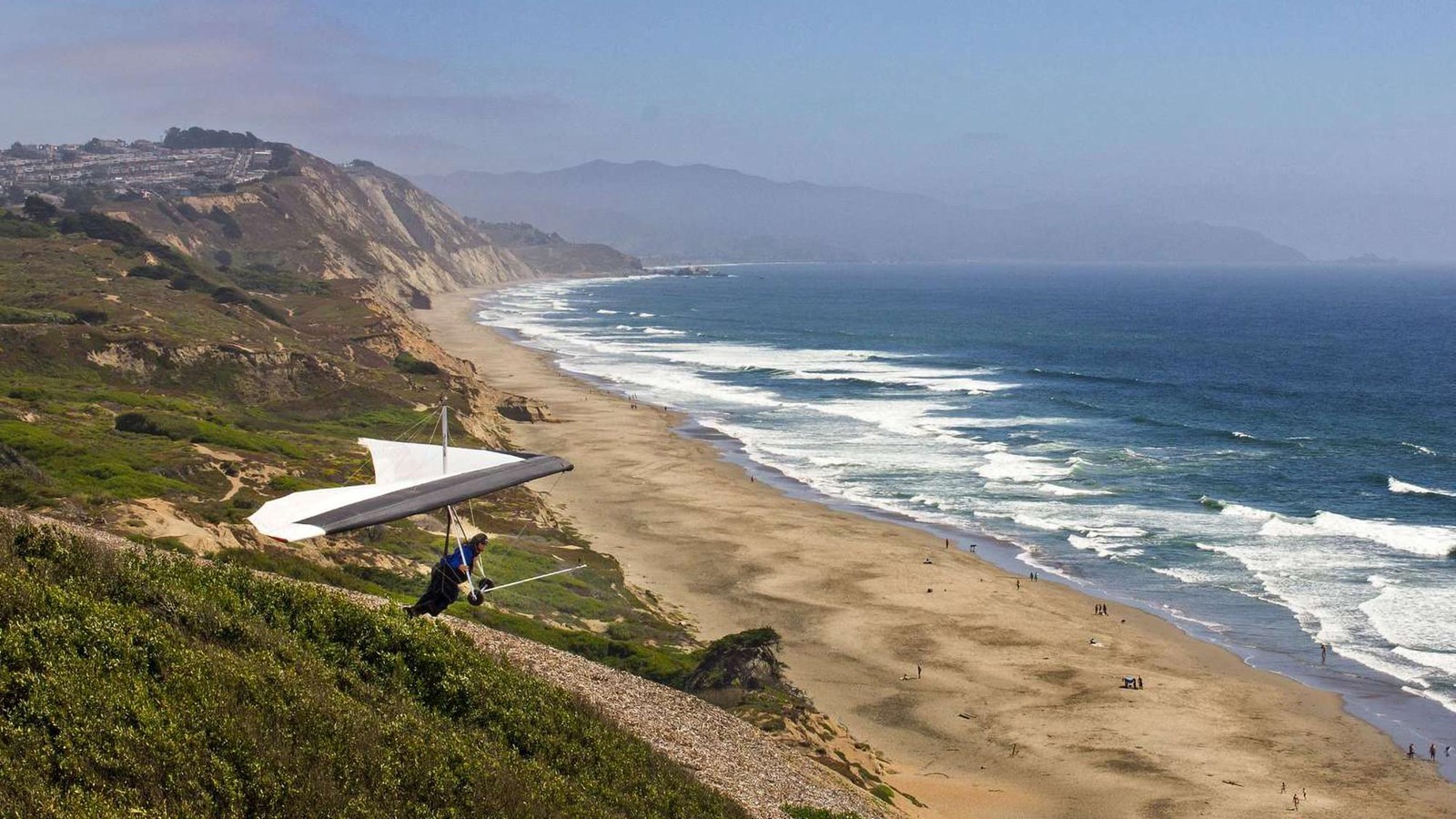 Hang glider preparing to lift off, overlooking Funston Beach. 