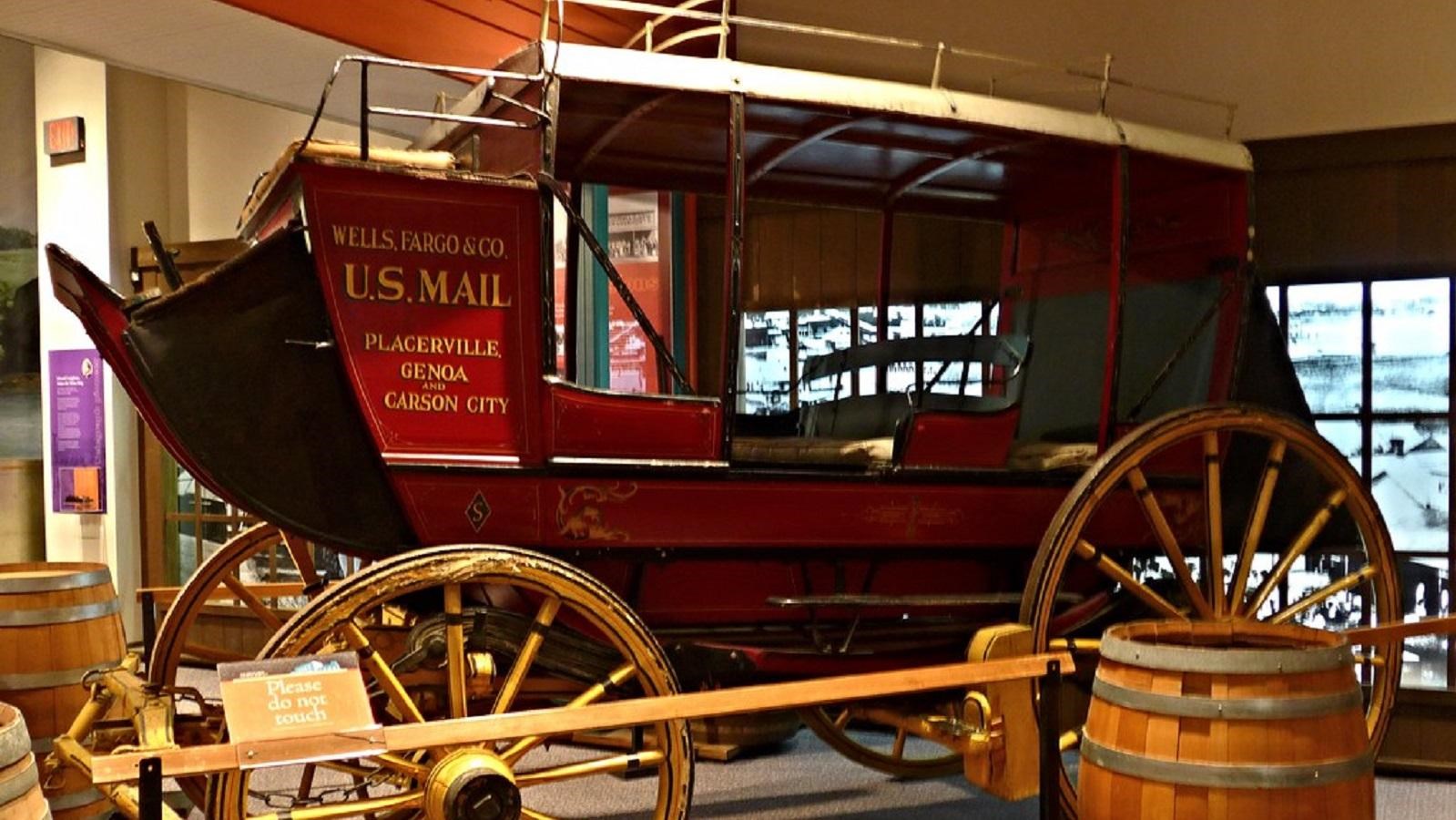 A barrel sits by a 19th century U.S. Mail stagecoach on display in the museum