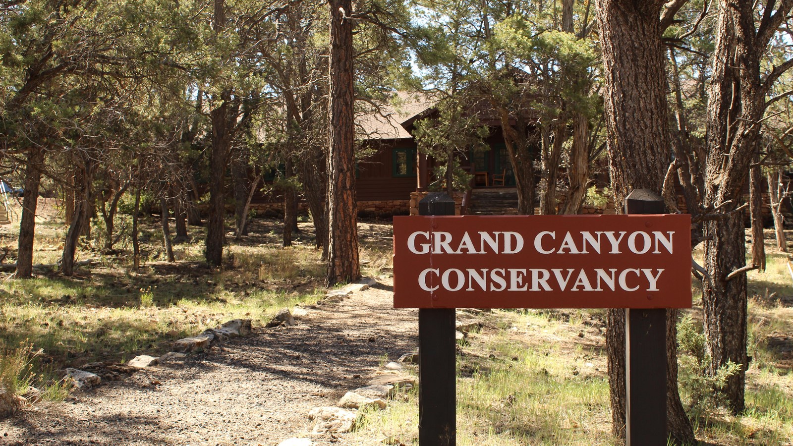 A brown wooden sign reads 