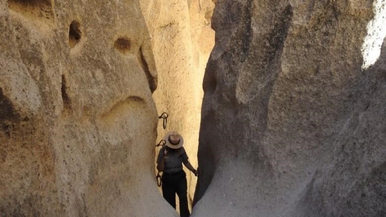 Ranger Climbs out of the Rings Trail. Ranger is in-between tall and narrow cliff walls