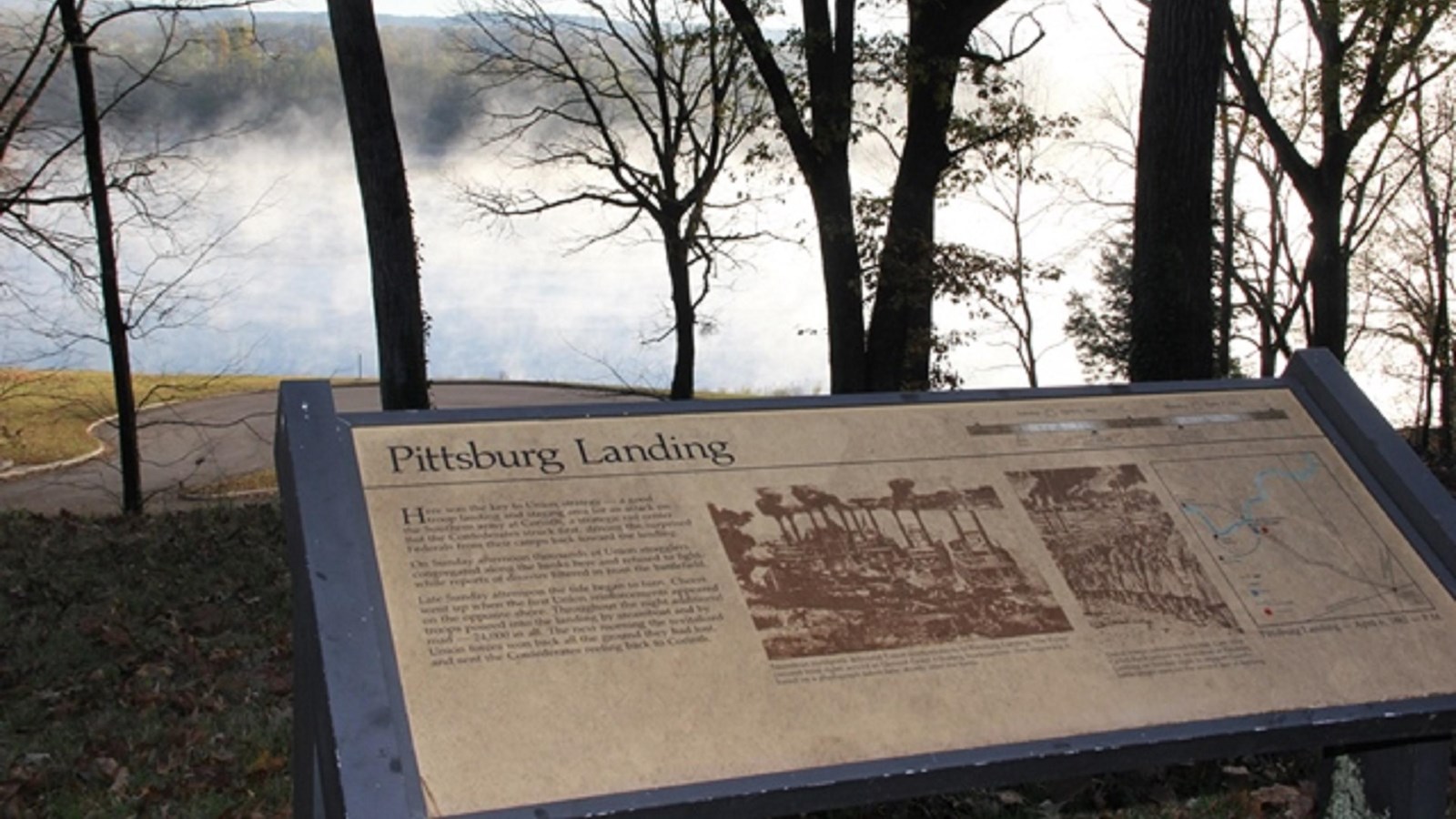 A park wayside exhibit overlooks the Tennessee River