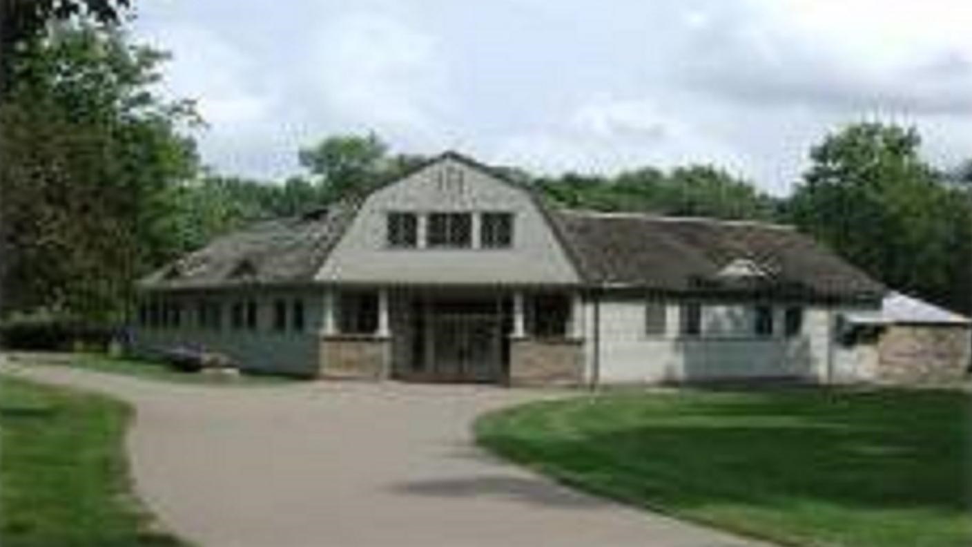 a beige building that looks like a barn