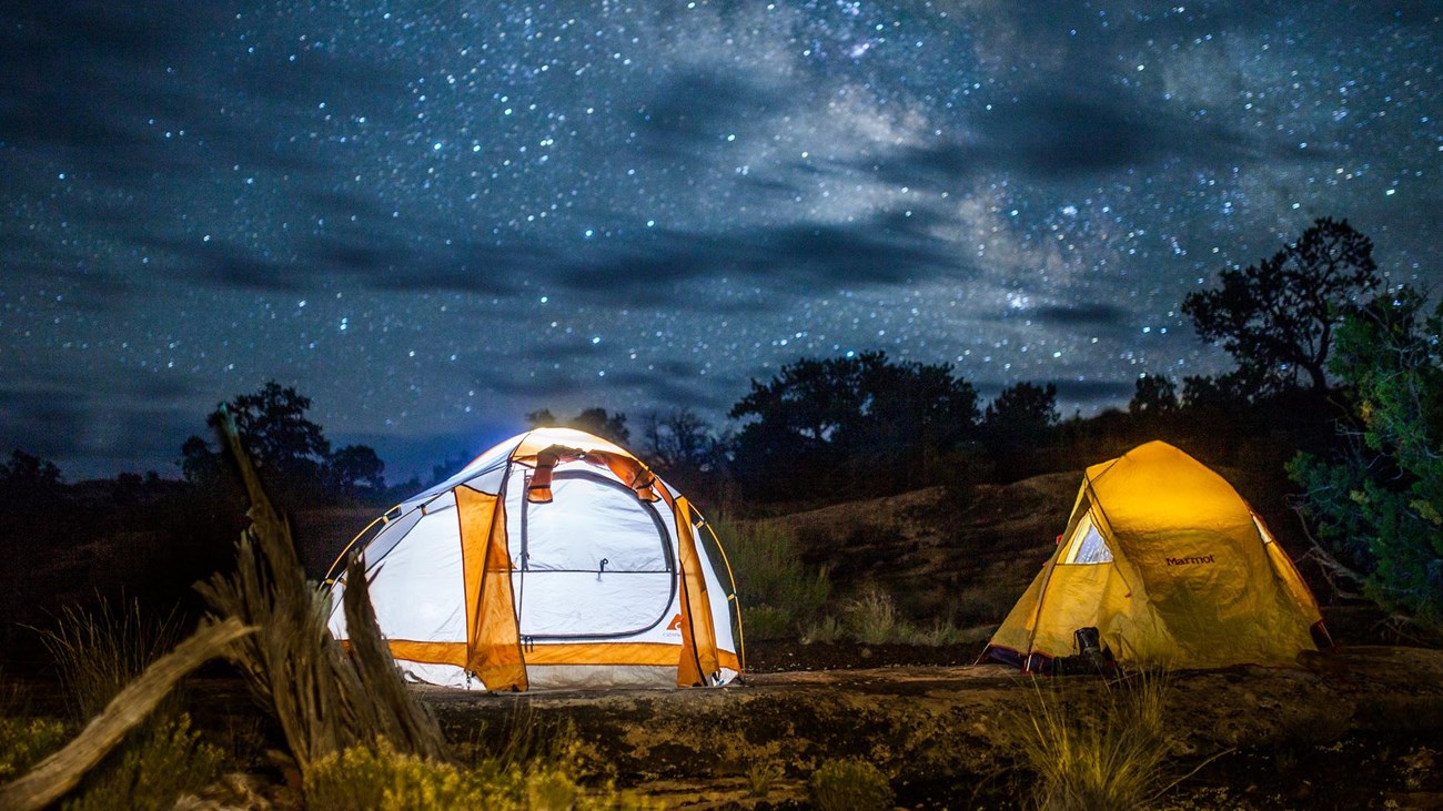 Two white and yellow tents illuminated the stars