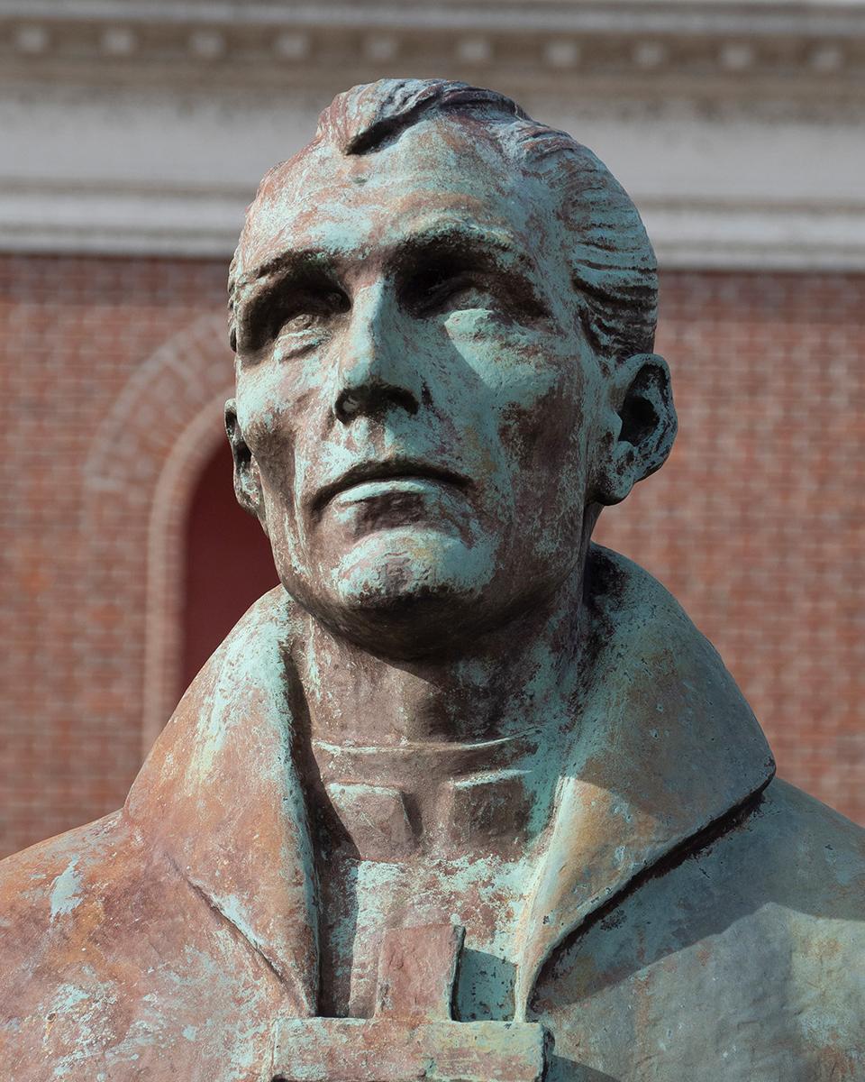 bronze statue of a Catholic Priest