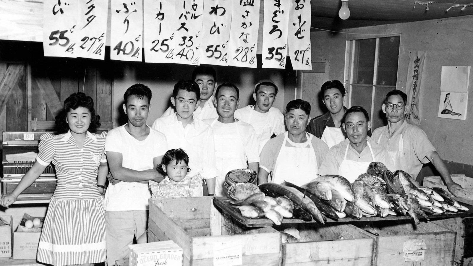 Group of people behind counter of fish