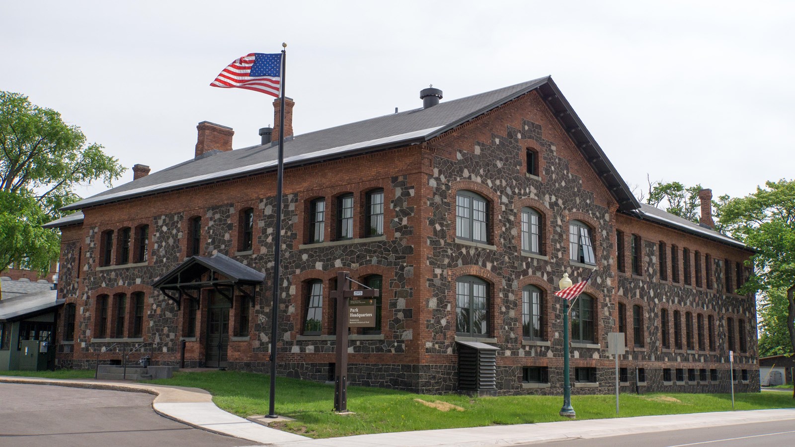 Large l-shaped two-story stone building on street corner