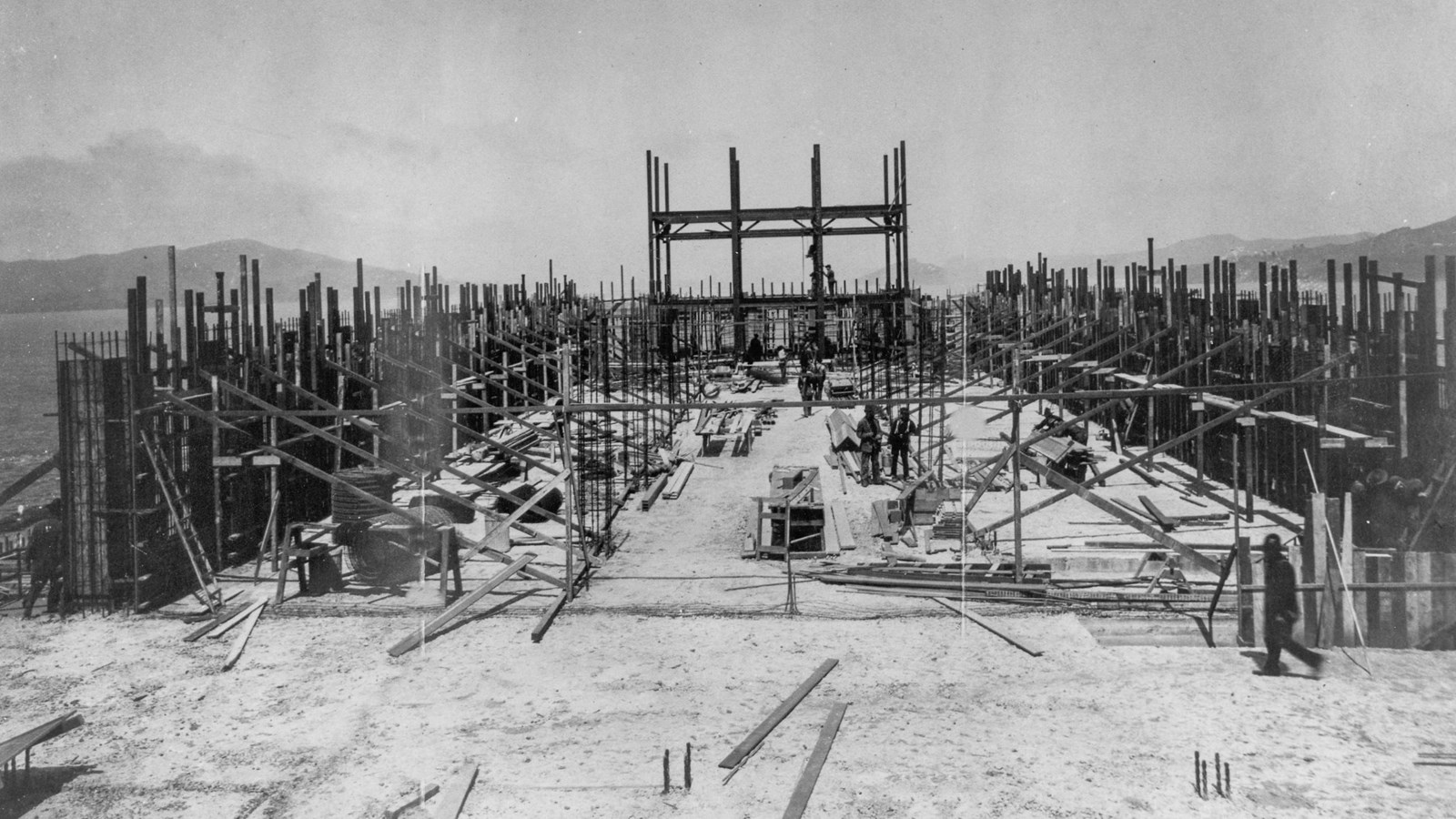 Black and white image of men constructing a new building on Alcatraz Island