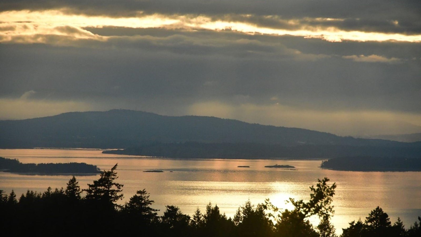 Color photograph of the sun setting on the sea as seen from above