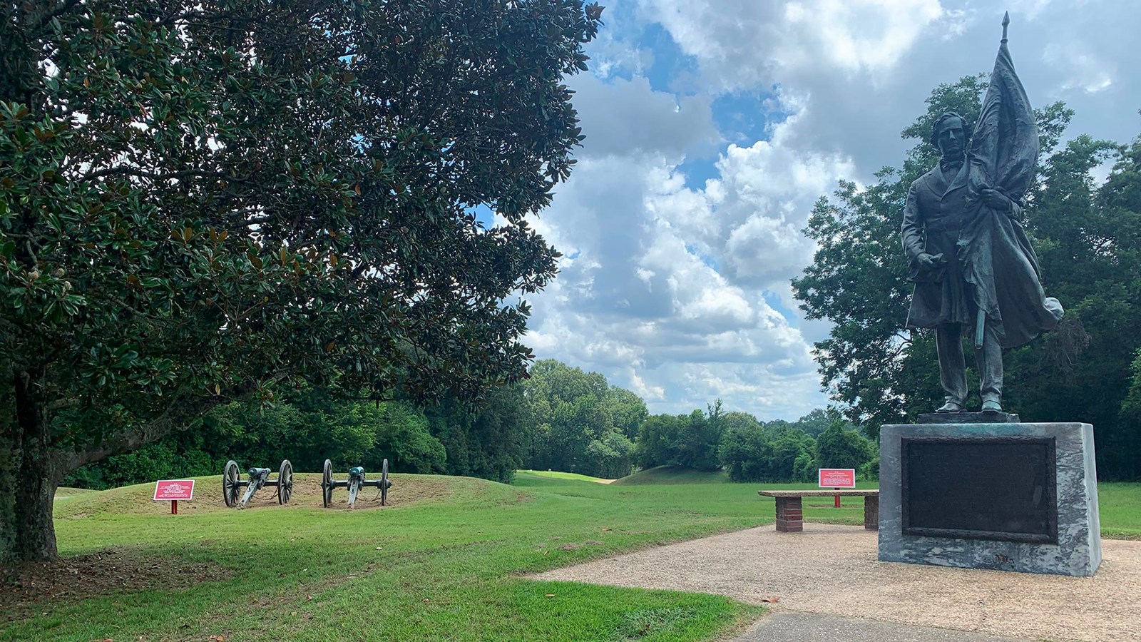 A magnolia tree stands beside a statue of Jefferson Davis on part of the 2nd Texas Lunette.