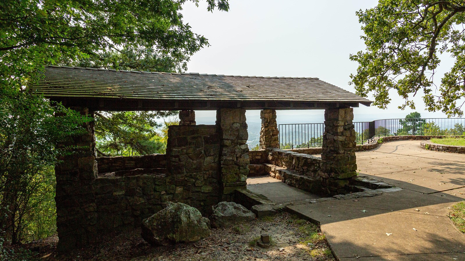 A stone house with exposed walls for viewing the vast overlook 