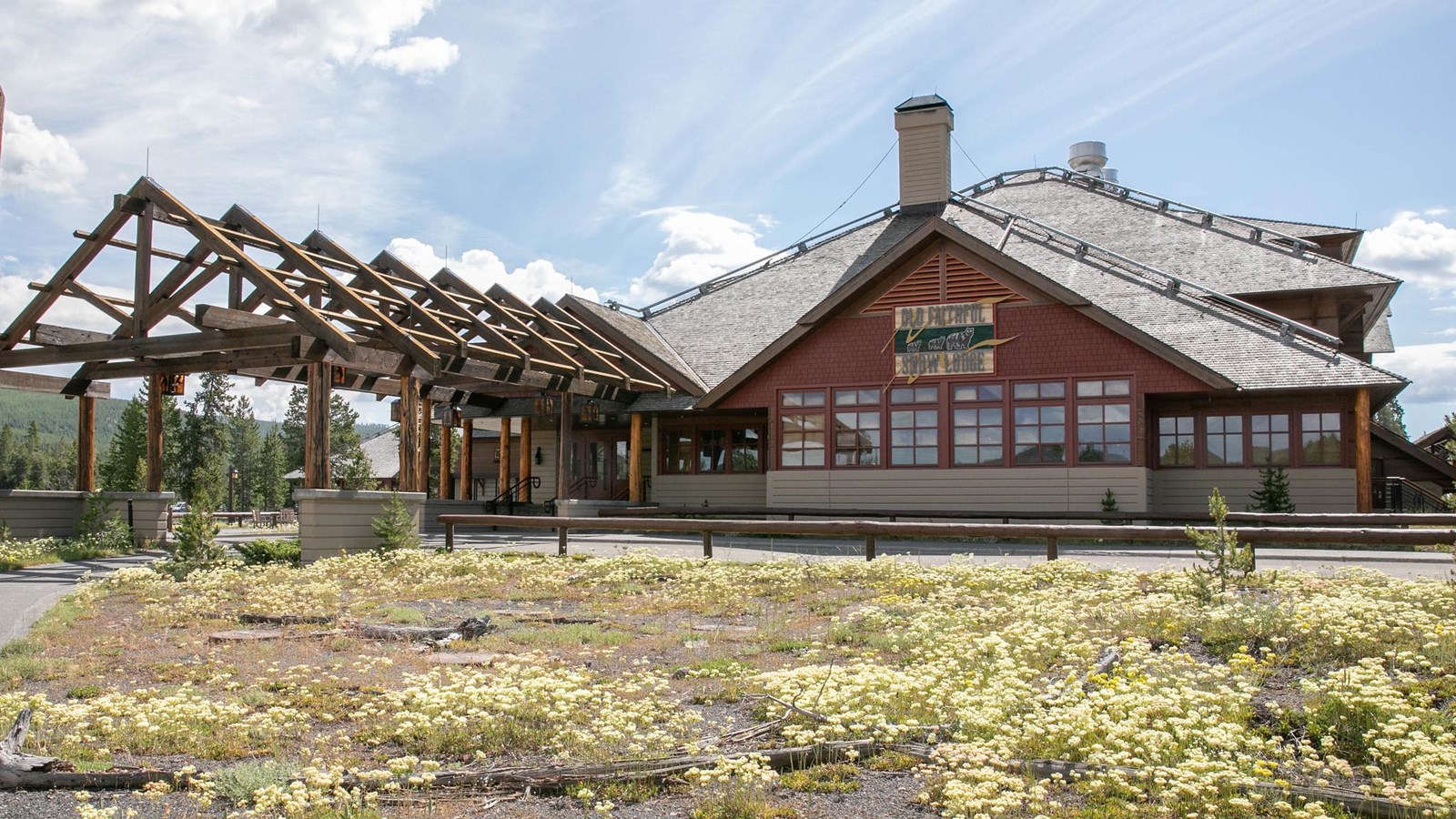 A modern building with red, shingle siding and windows.