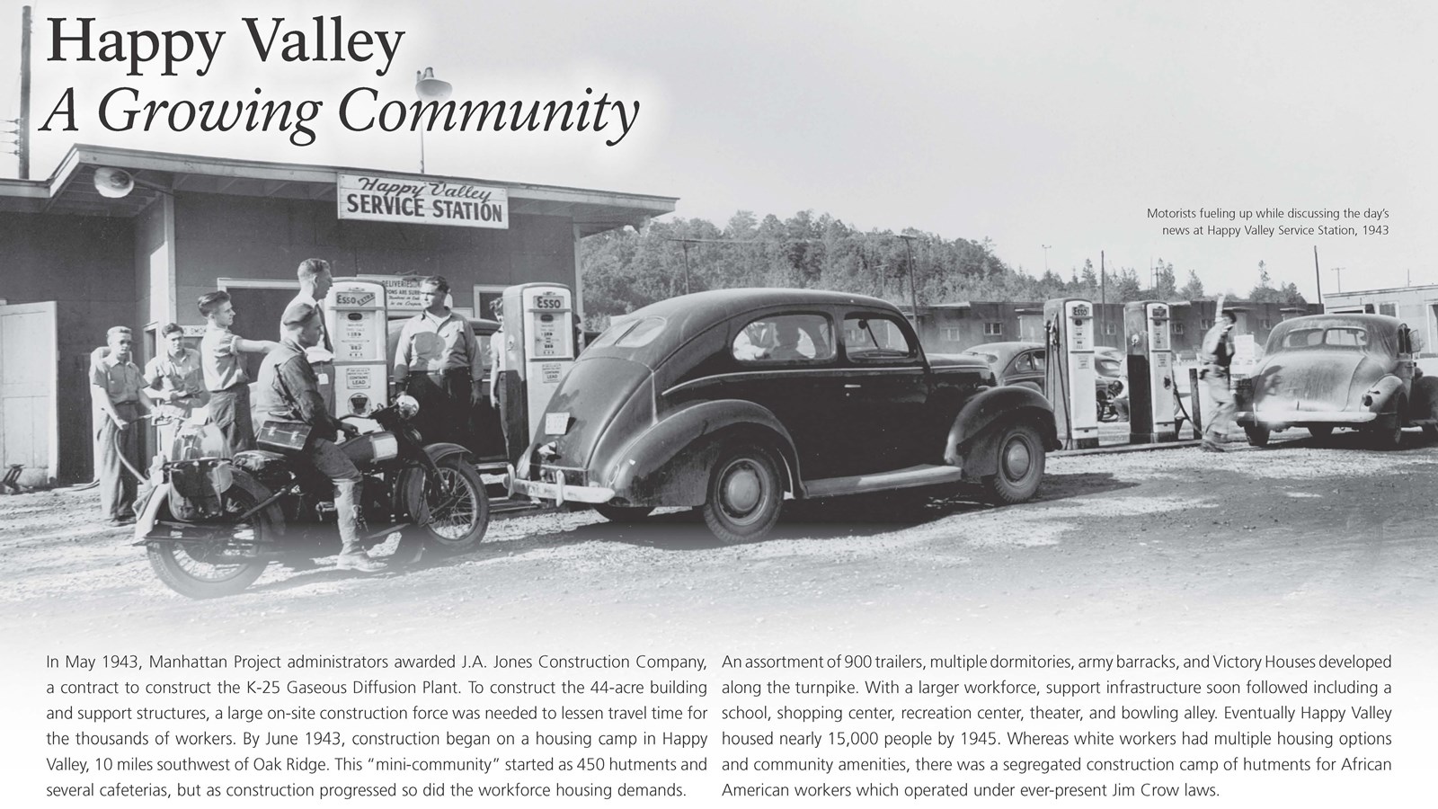 A wayside with text and an image of a gas station with cars and a motorcycle.