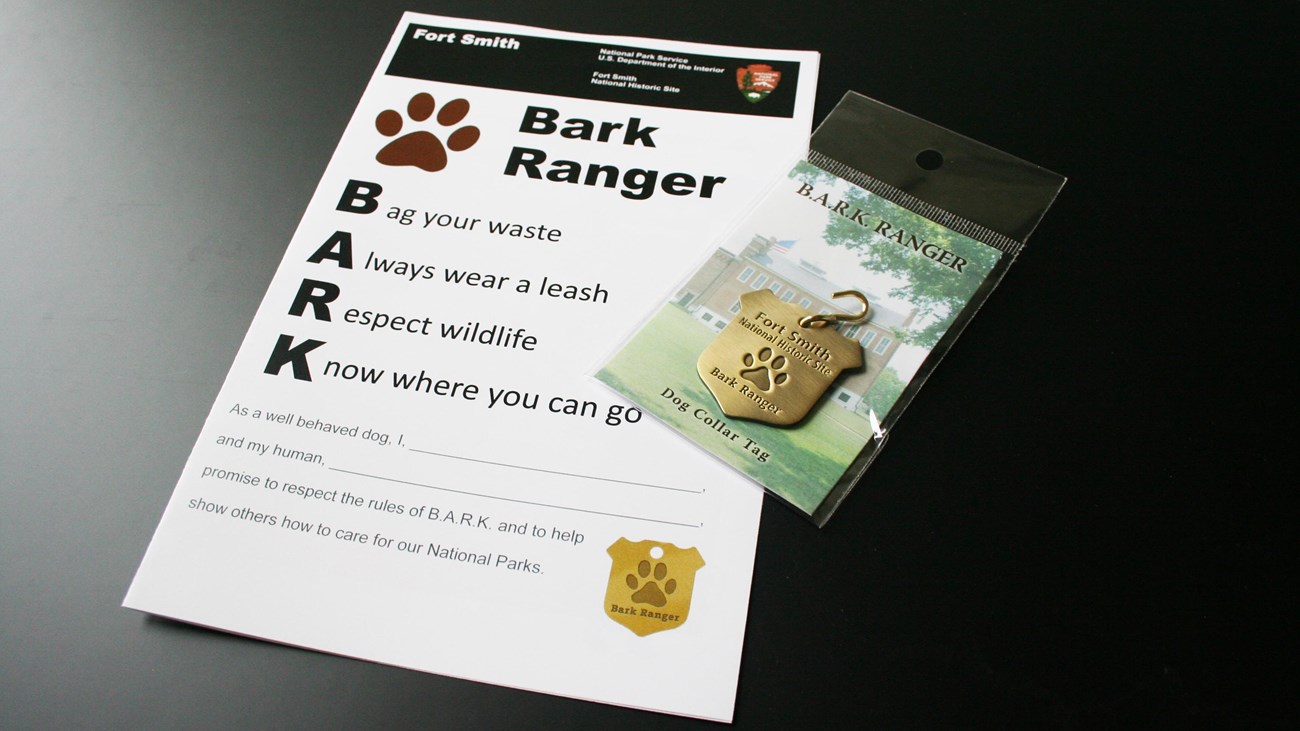 A handout titled BARK Ranger and the Fort Smith BARK Ranger dog tag.