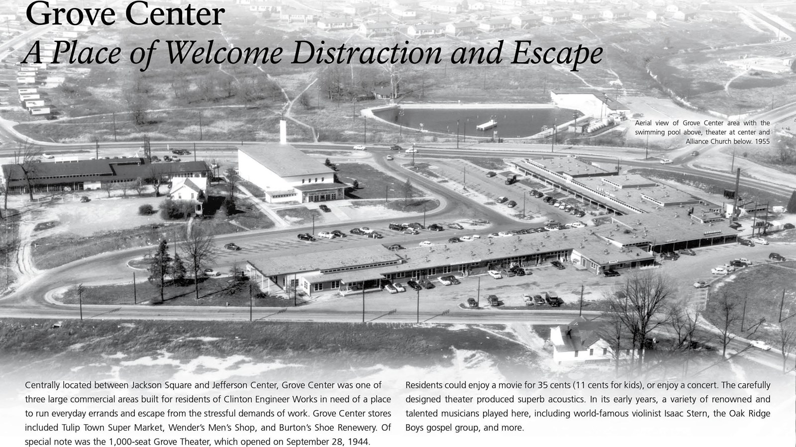 A wayside with text and an aerial view of a shopping center.