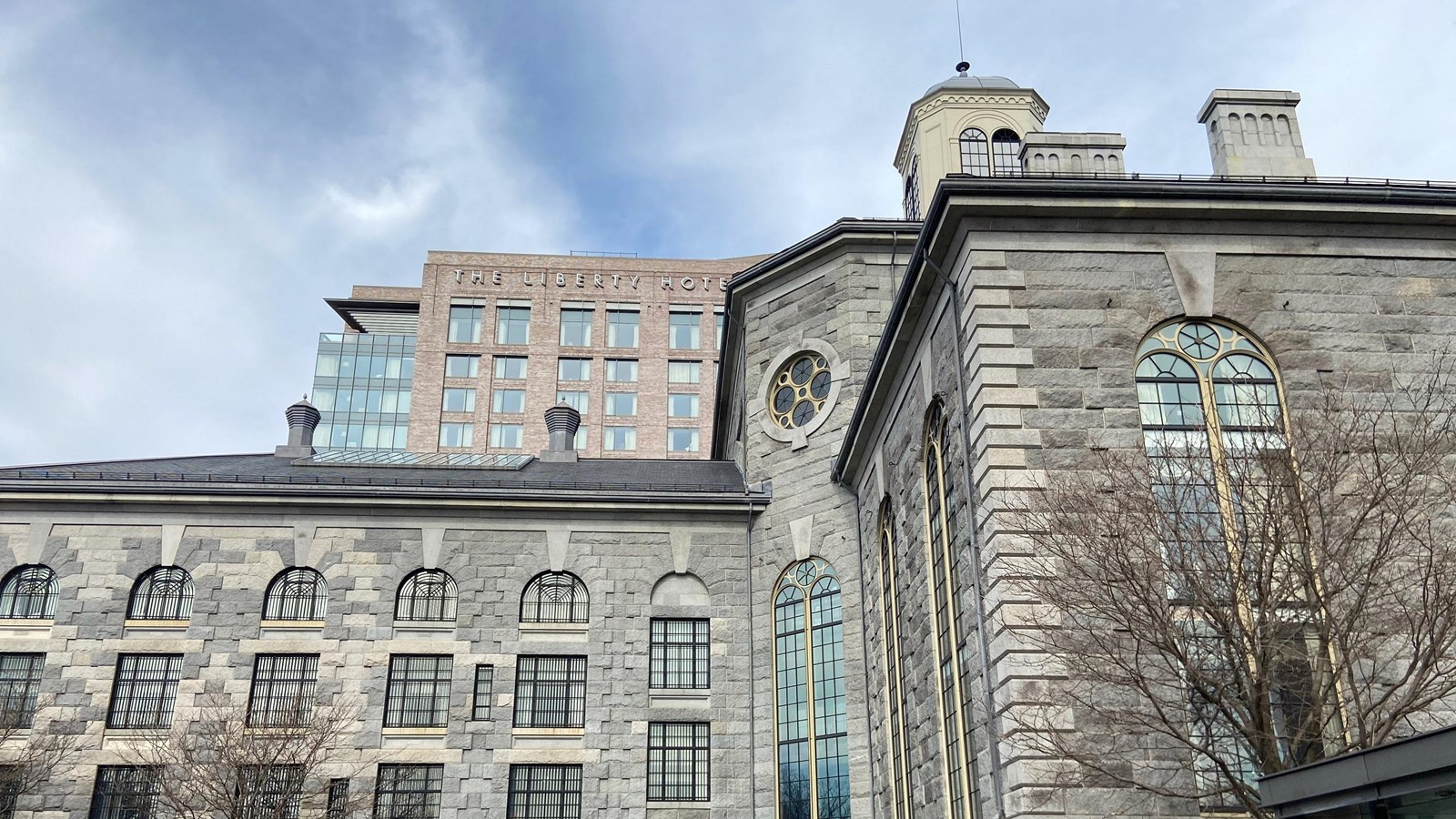 Entrance to large, gray-stoned building in an L-shape