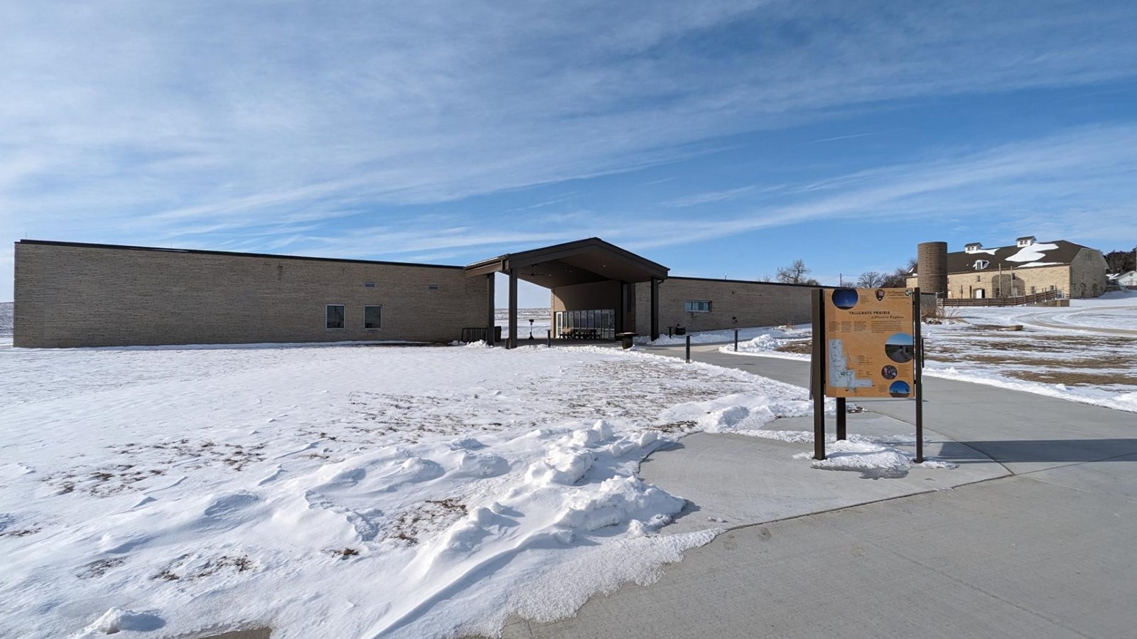 Visitor center with barn in background and kiosk in foreground