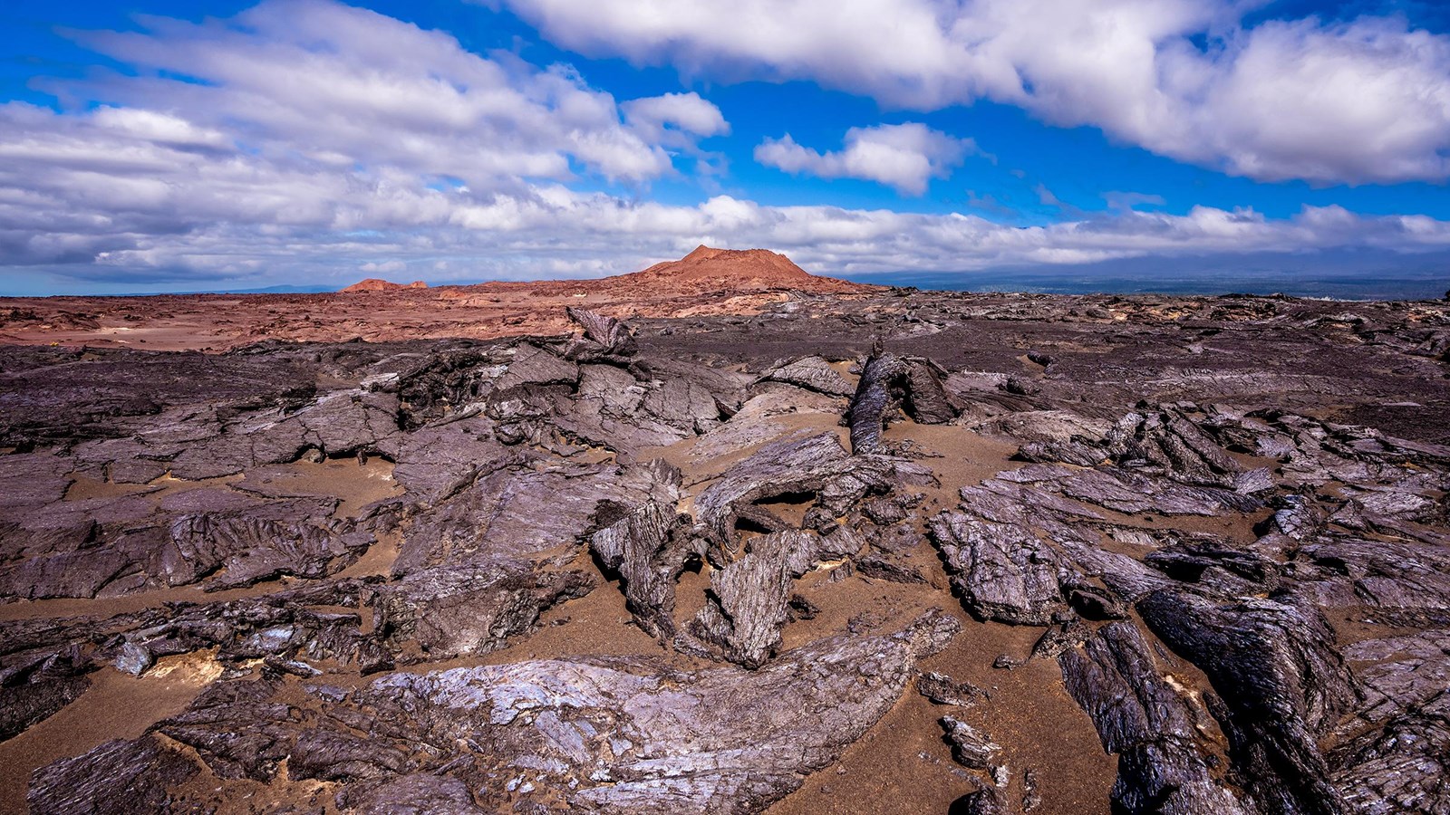Two volcanic cones surrounded by more recent lava flows from the 1974 eruption.