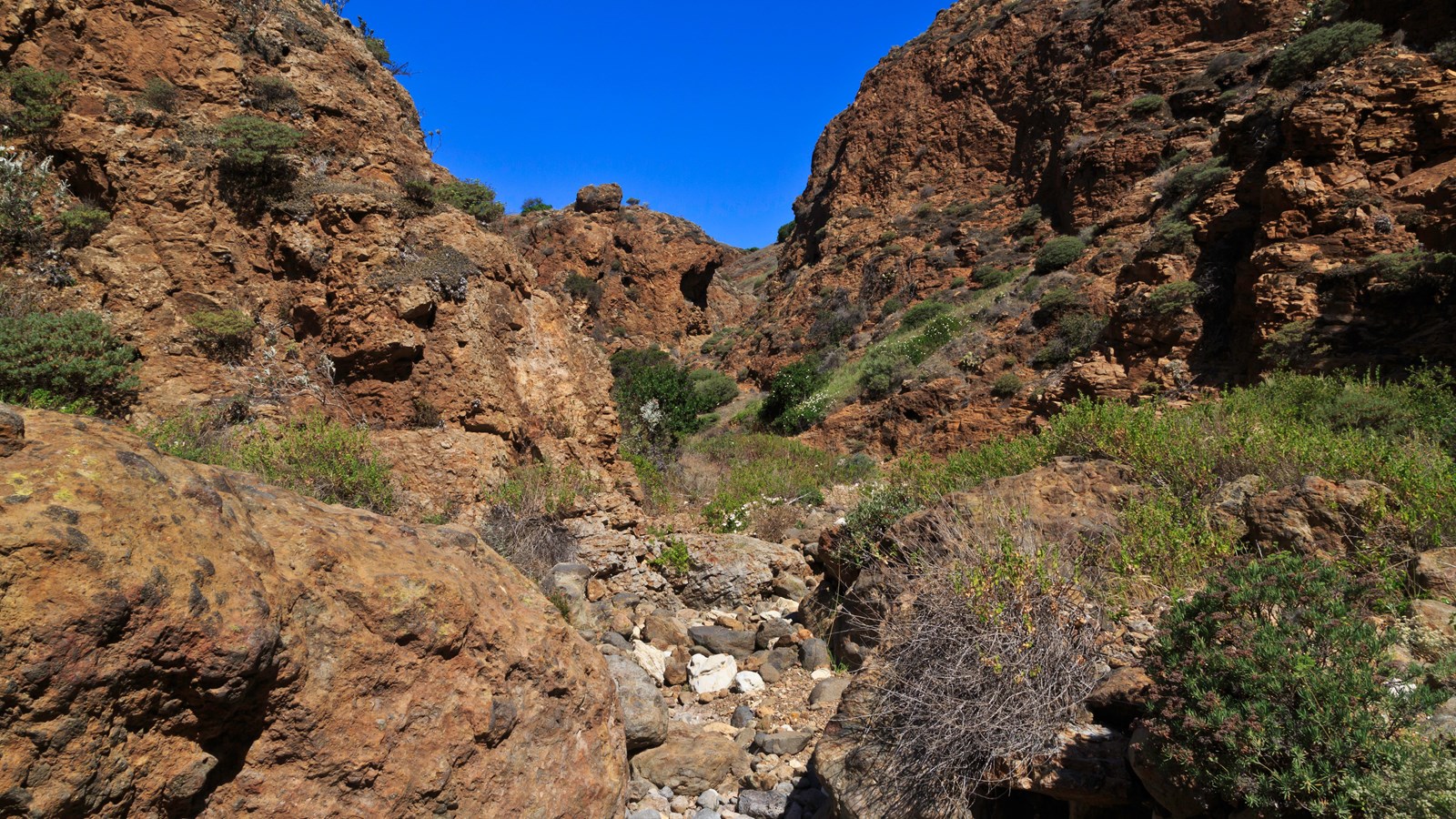narrow canyon with steep volcanic walls and rocky stream bed