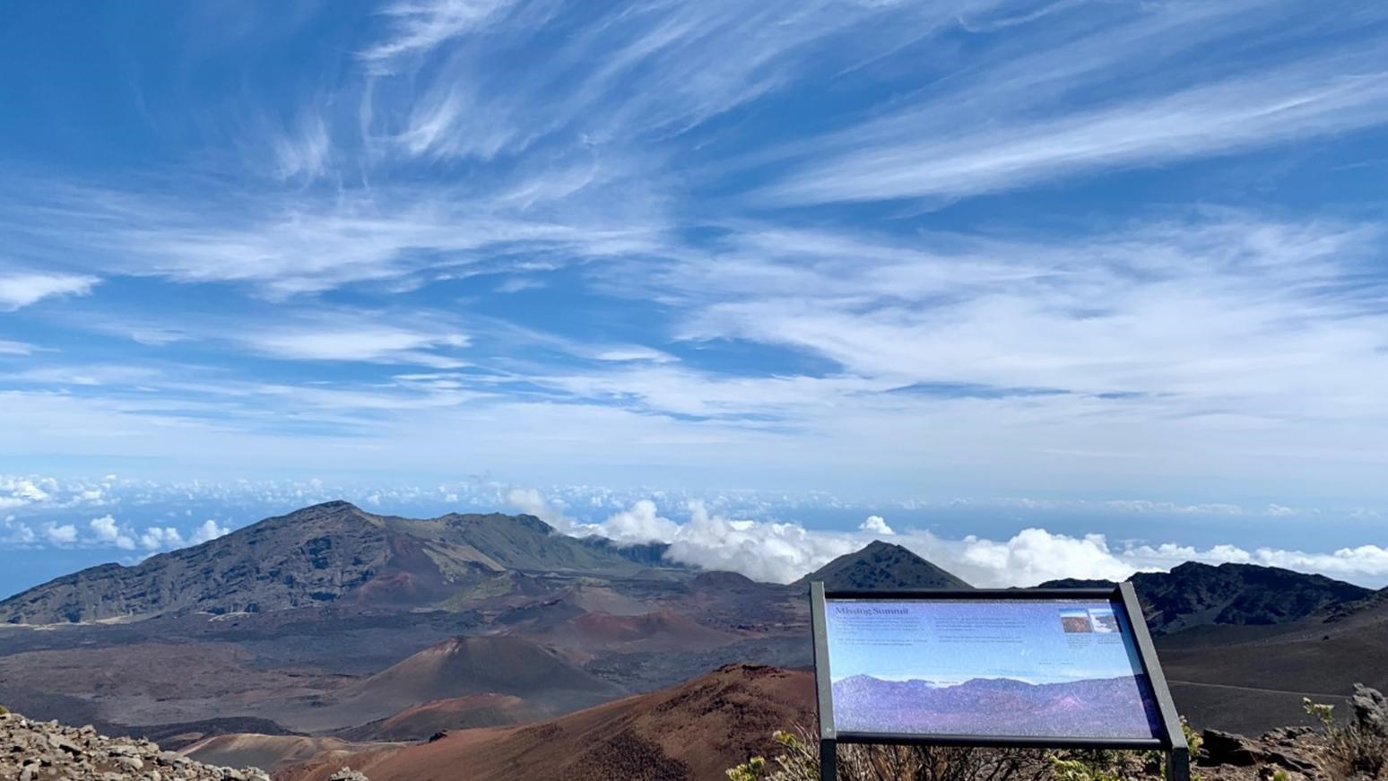 A sign at an overlook viewing the volcanic valley.