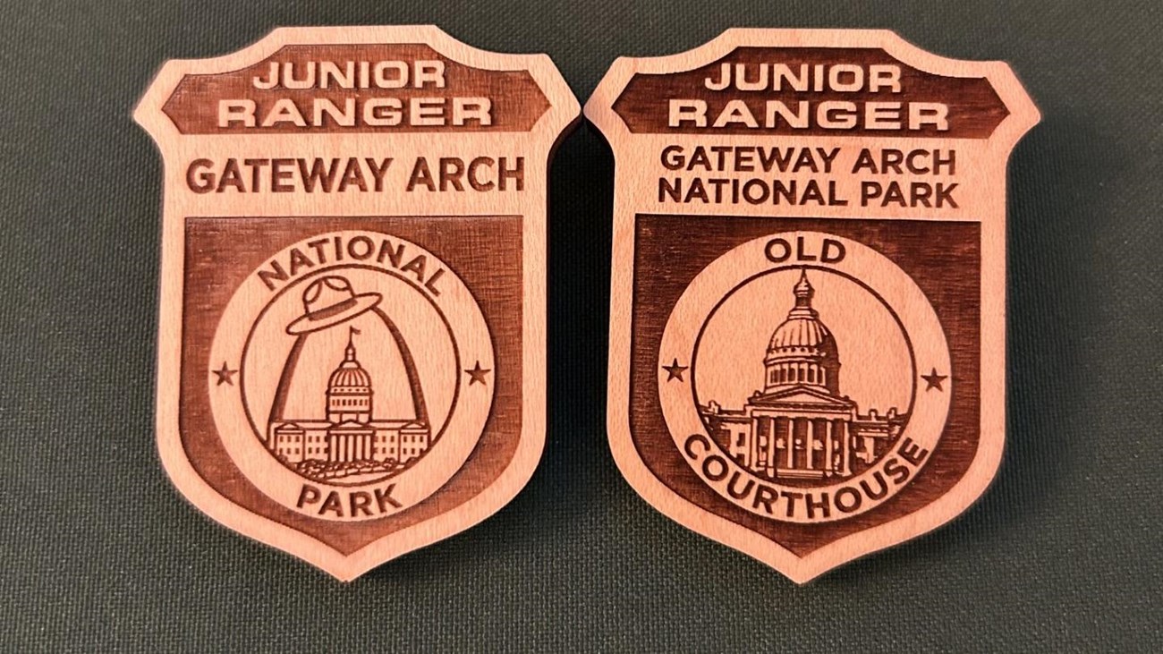 Two wooden badges sit side by side