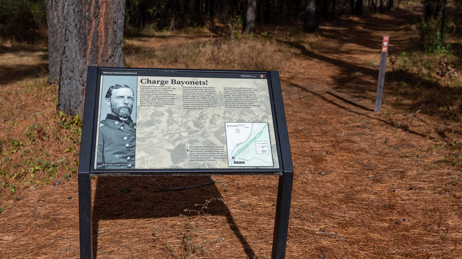 A photo of a soldier with a buttoned jacket is displayed next to a trail map.