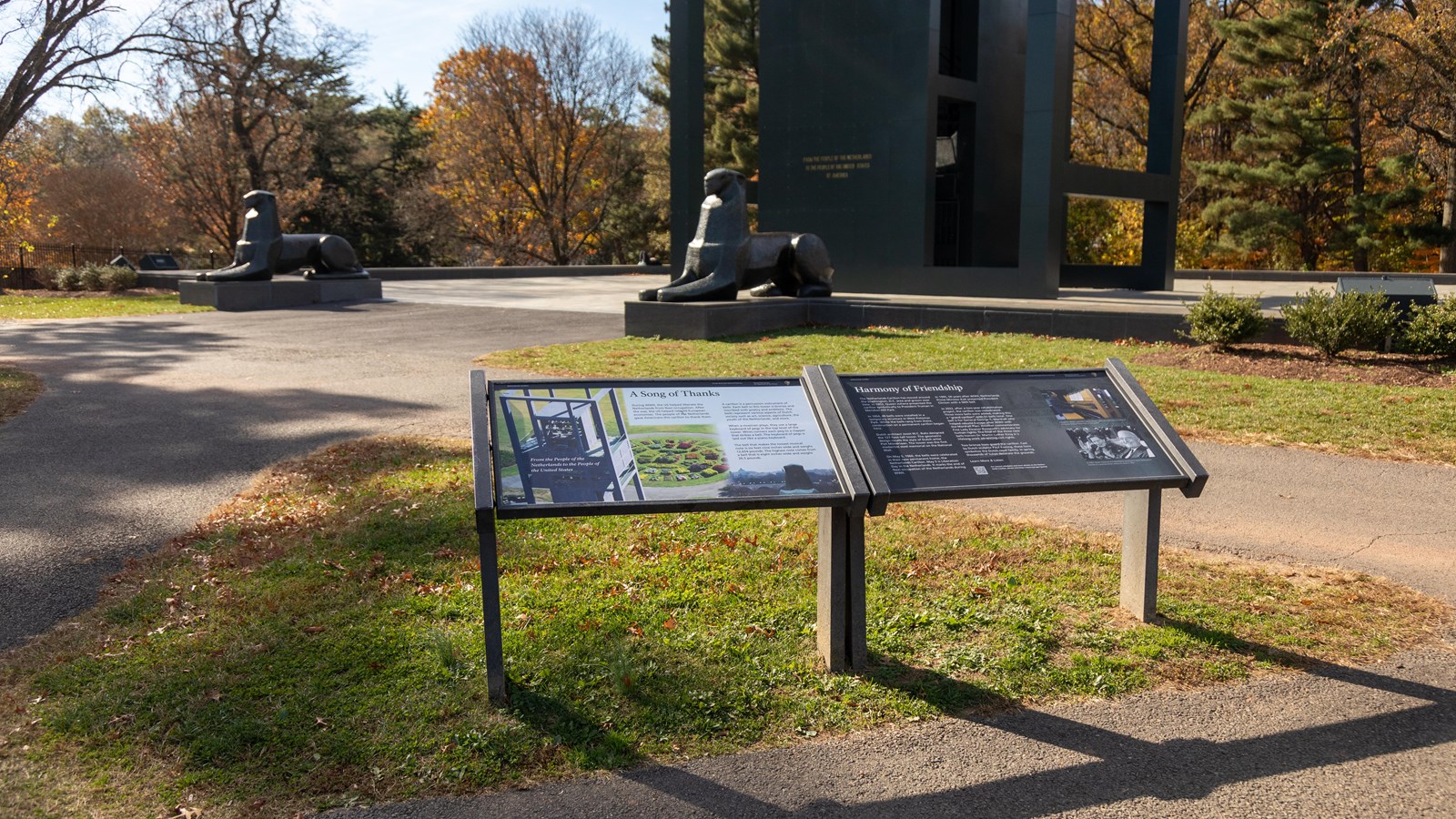 An image of a tall, box-shaped structure peering down on a circle of colored bushes is displayed.
