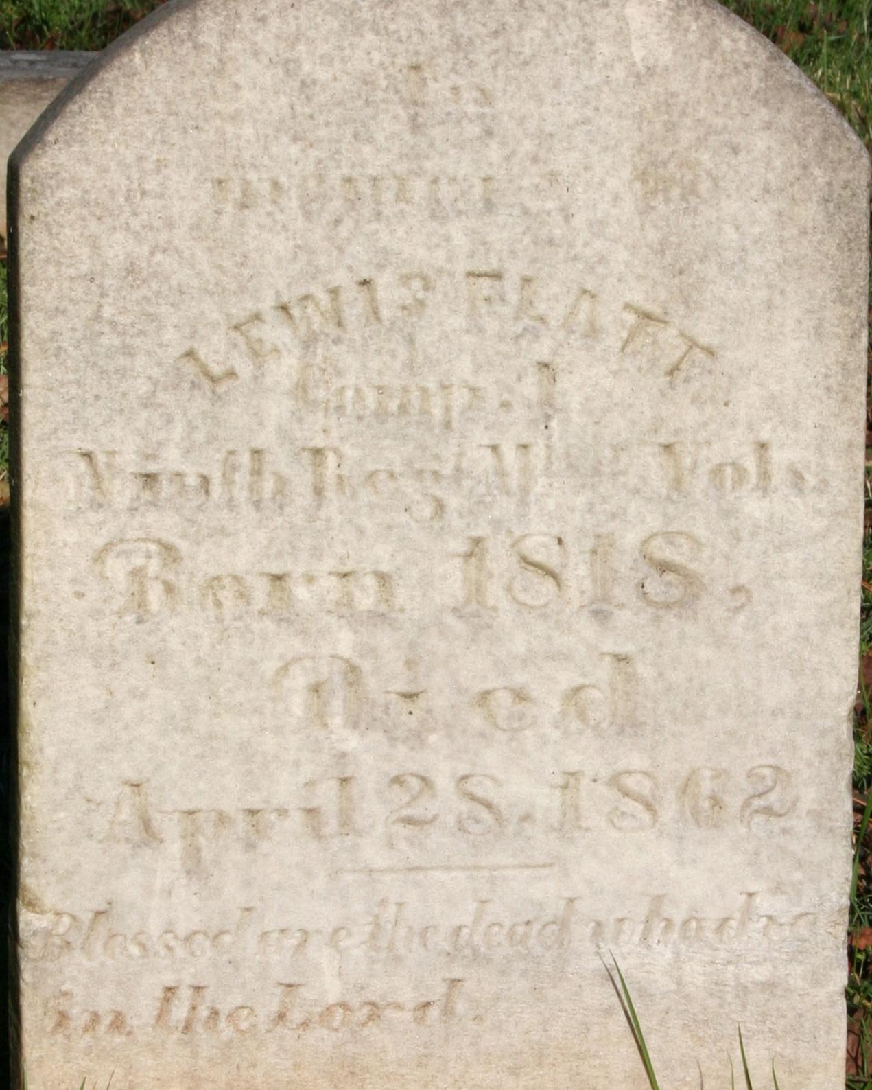 Rounded marble headstone belonging to Lewis Flatt located in the Stones River National Cemetery.