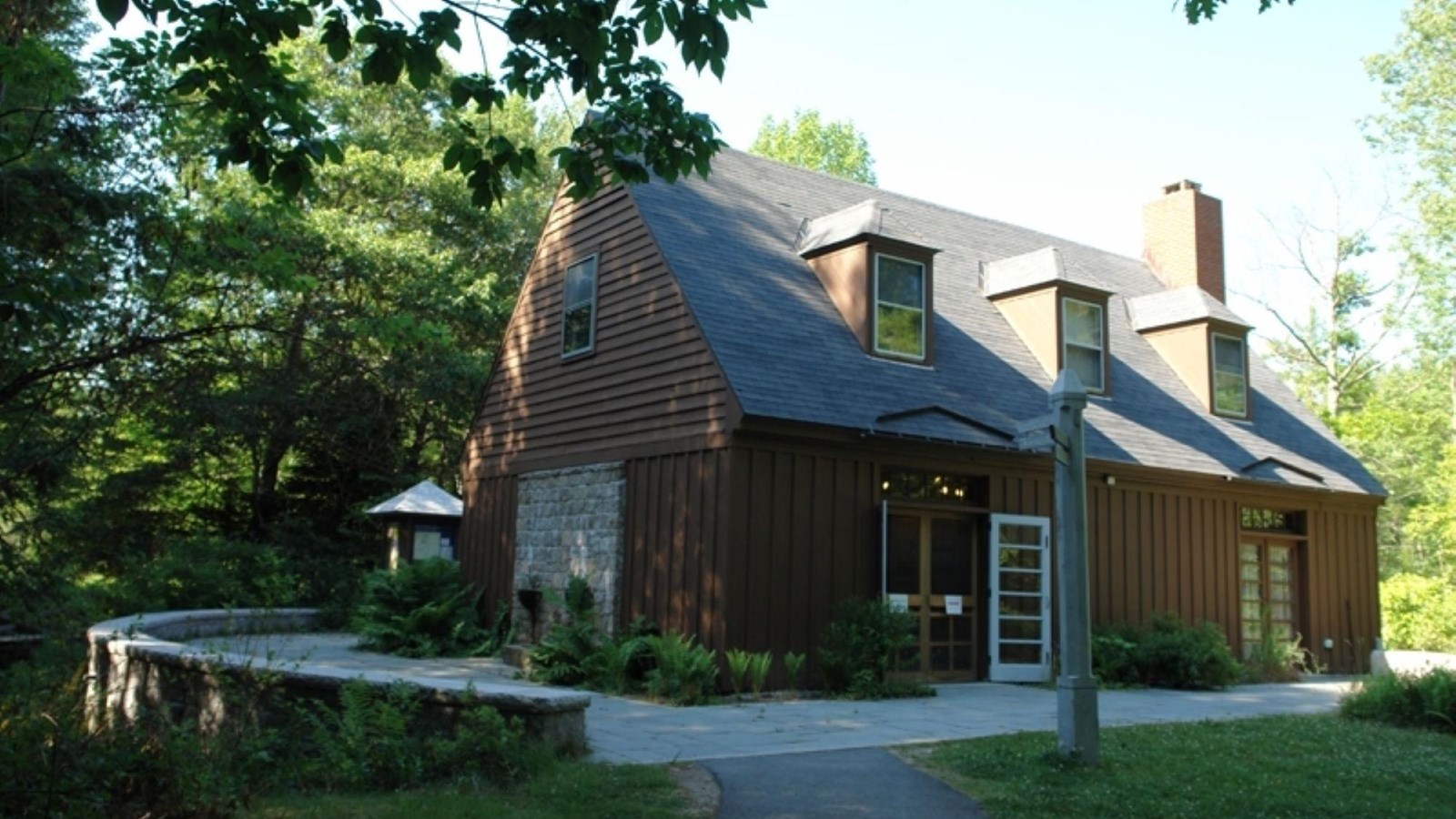 Brown building with stone terrace surrounding it