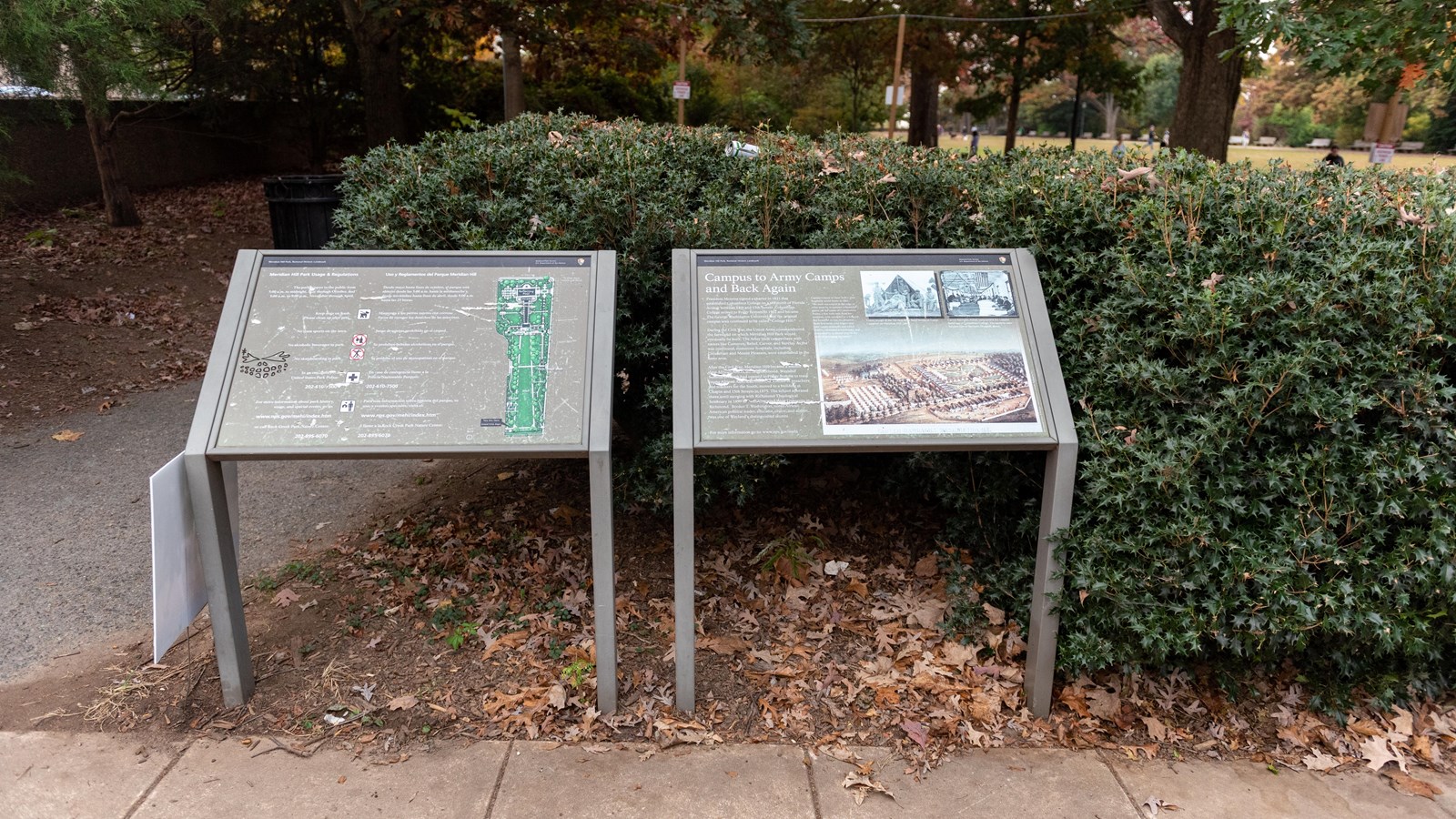 Two informational panels next to a sidewalk. 