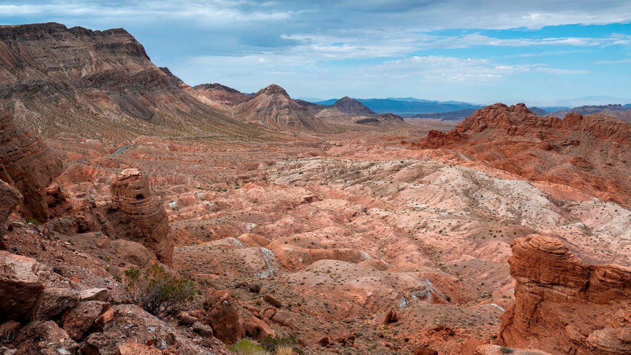 A cloudy sky over a mountainous landscape.