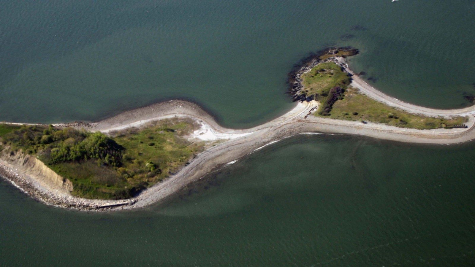 aerial view of an island with two different triangular spots of land connected by a spit.