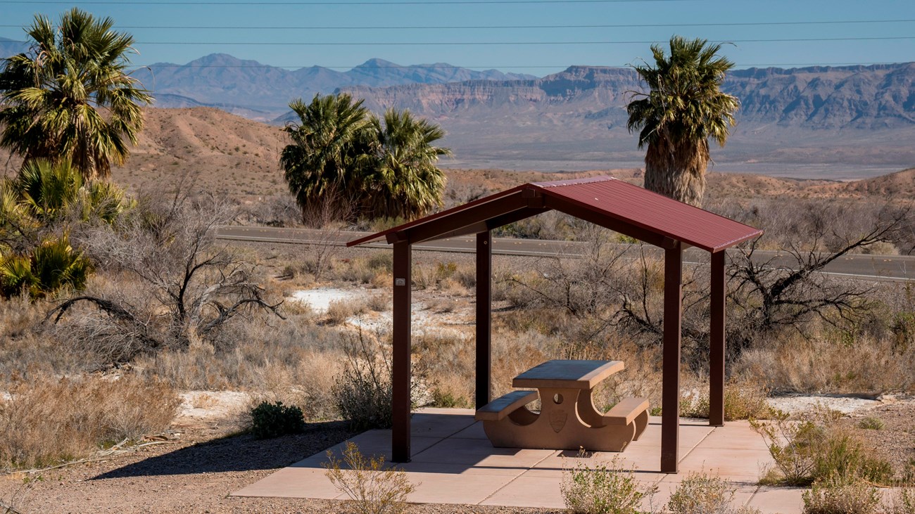 A picnic shelter with a desert landscape