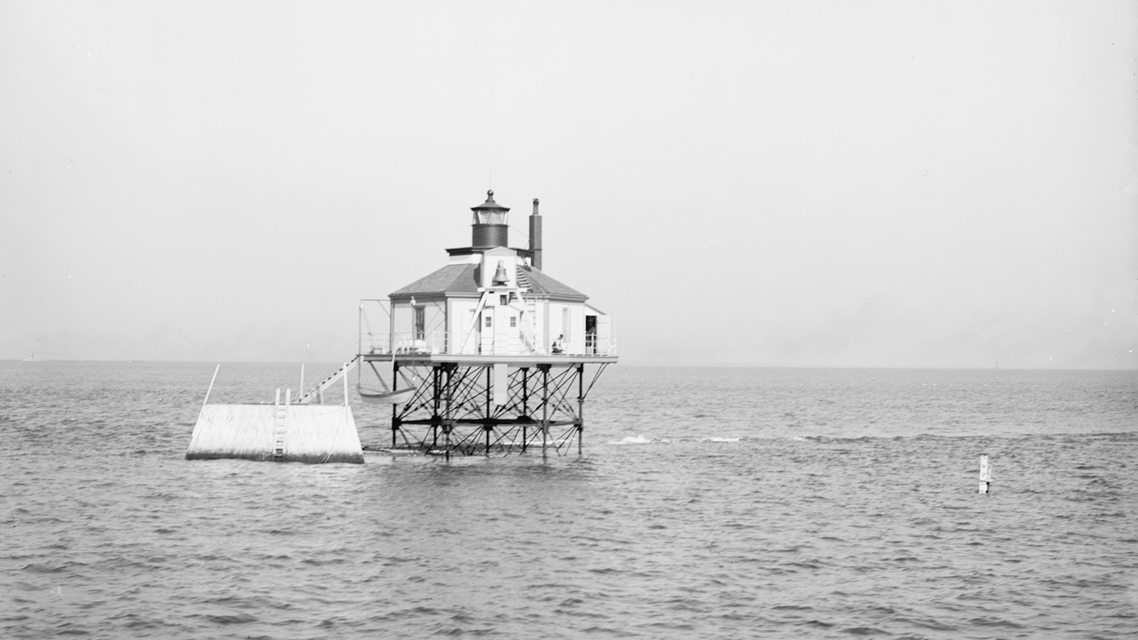 A light house on posts above the water, making it look like a bug. 