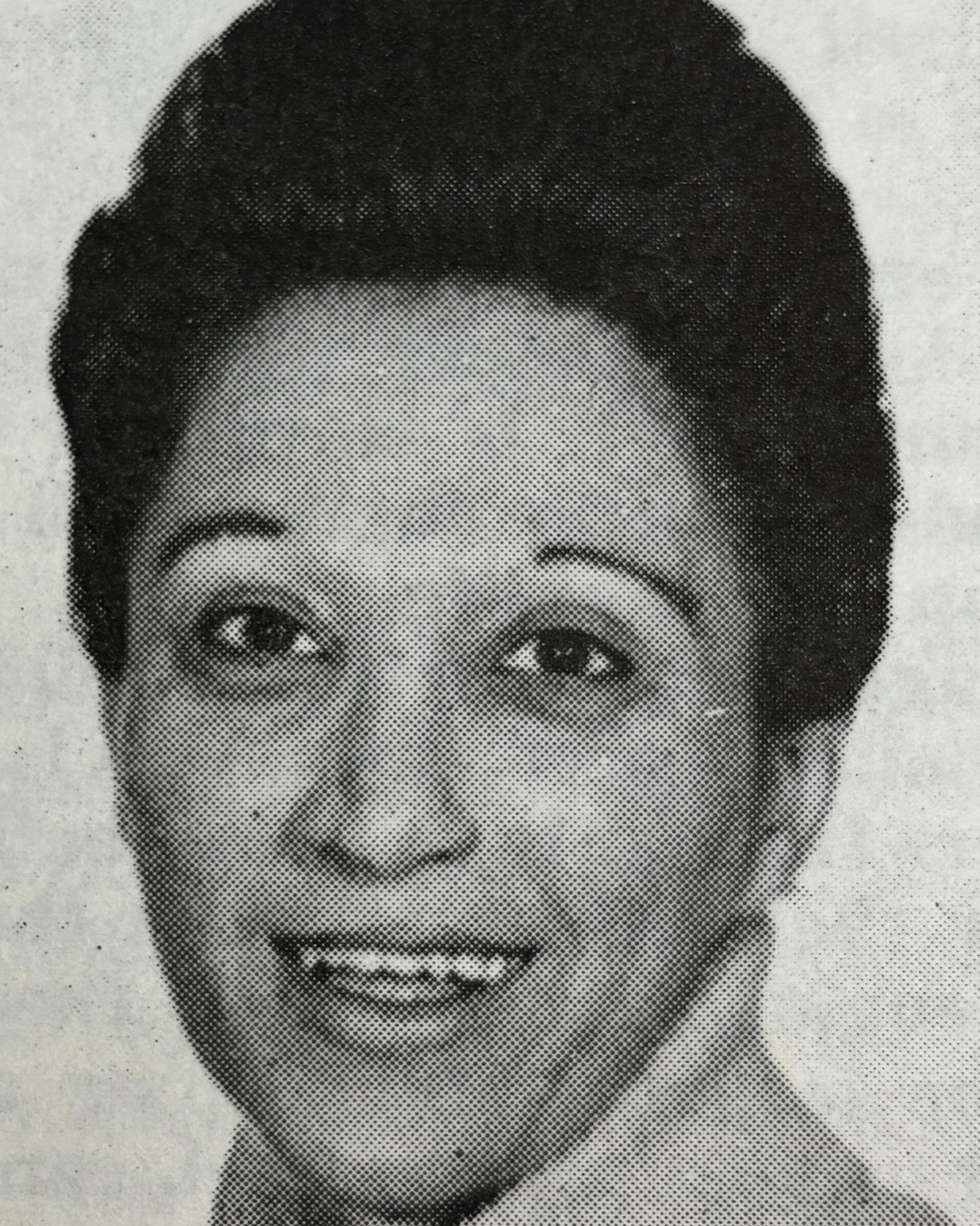 A portrait picture of a woman with dark hair smiling.