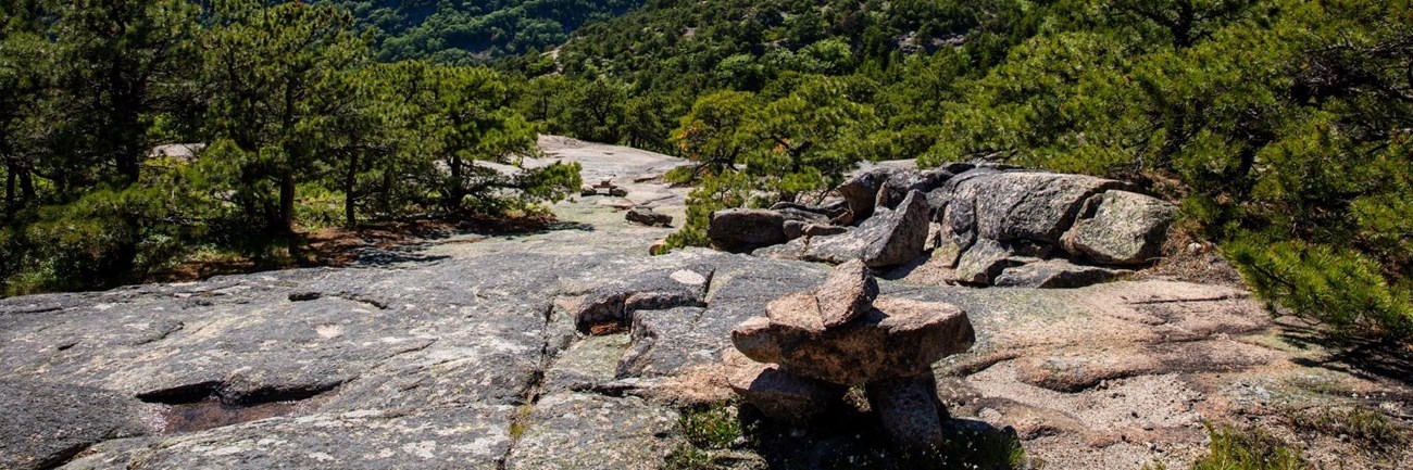 Rock cairns mark a trail on exposed rock