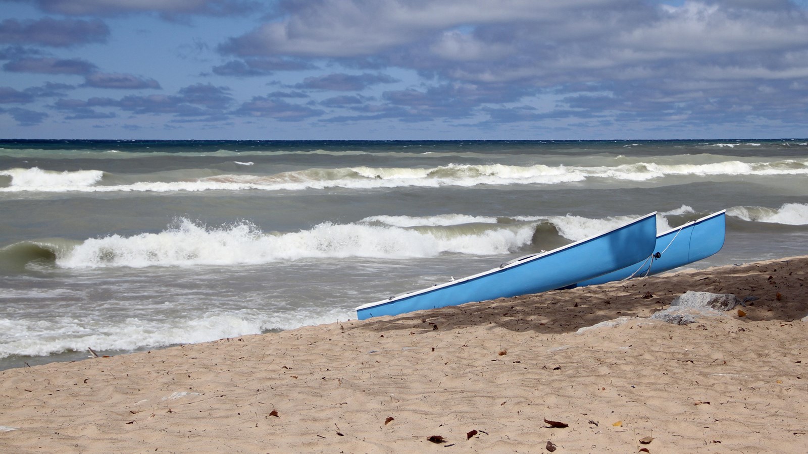 Photo of canoes sitting on Portage Lakefront and Riverwalk shoretline.