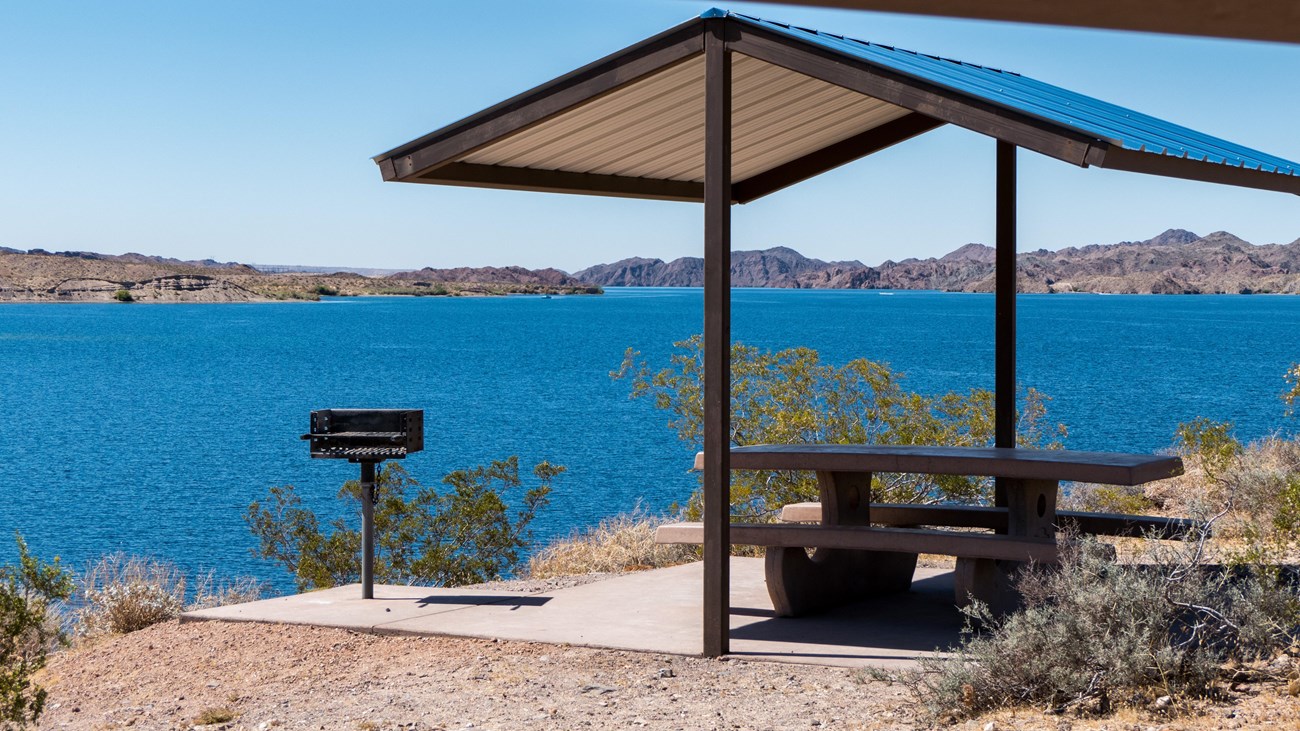 a picnic shelter next to a body of water