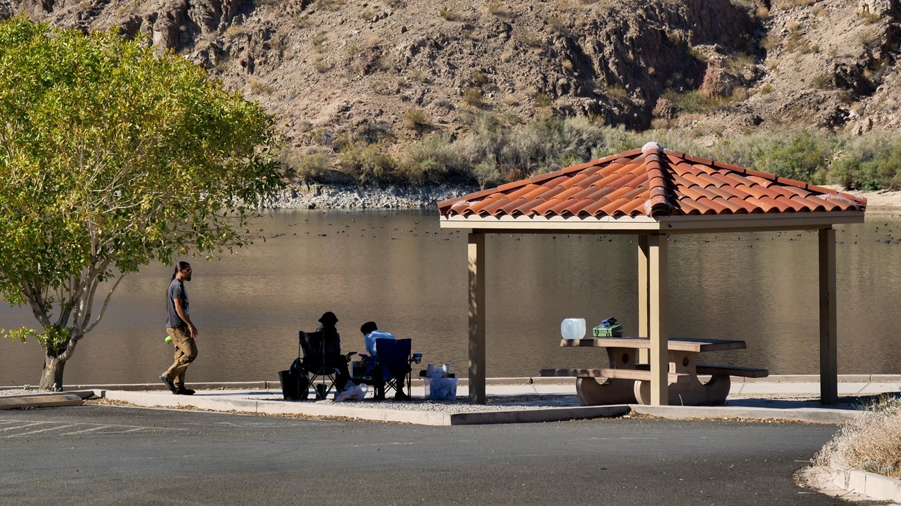 a picnic shelter next to water