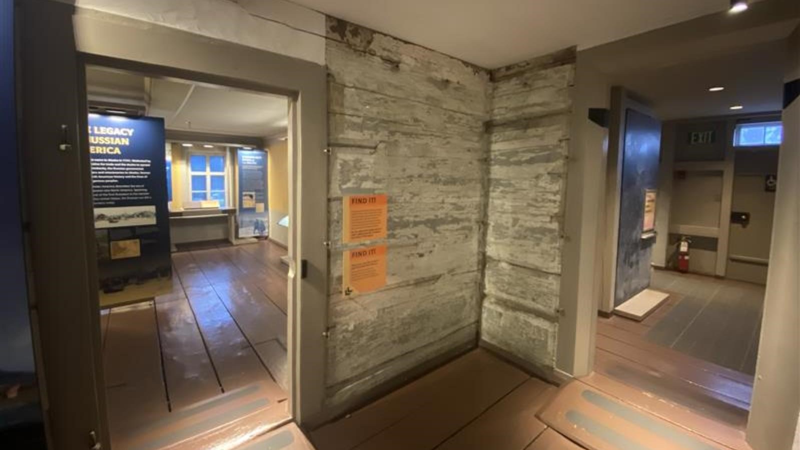 two doorways on either side of a corner of a historic wall that has old paint