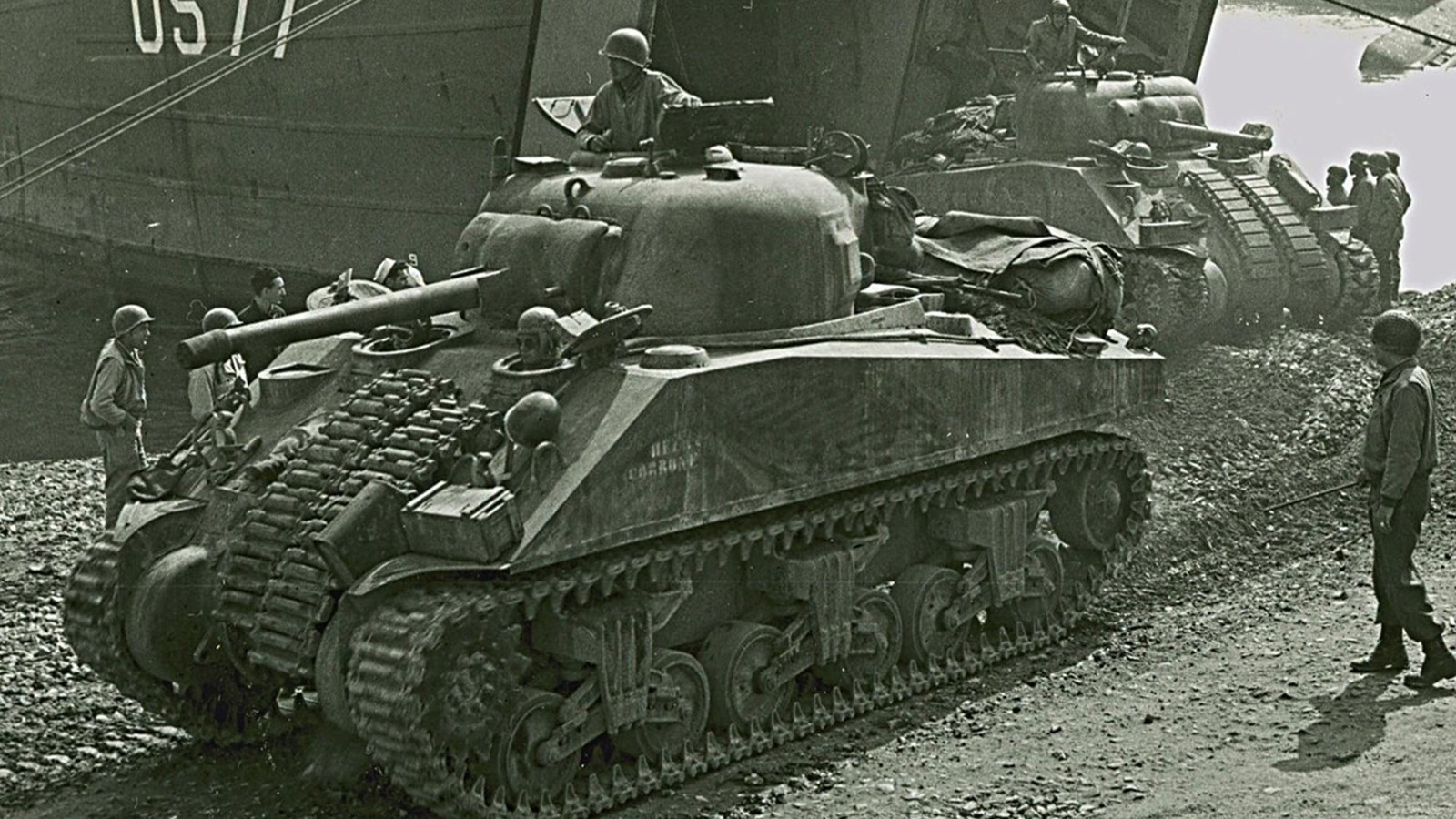 Large metal vehicle with uniformed man inside