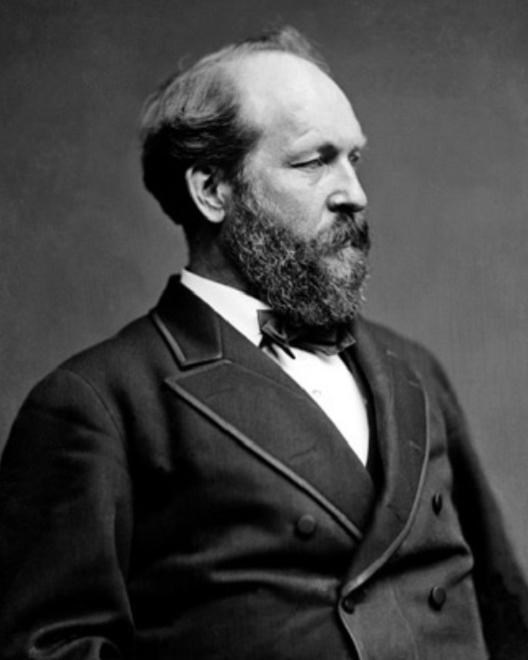 black and white photo of a man wearing a dark suit