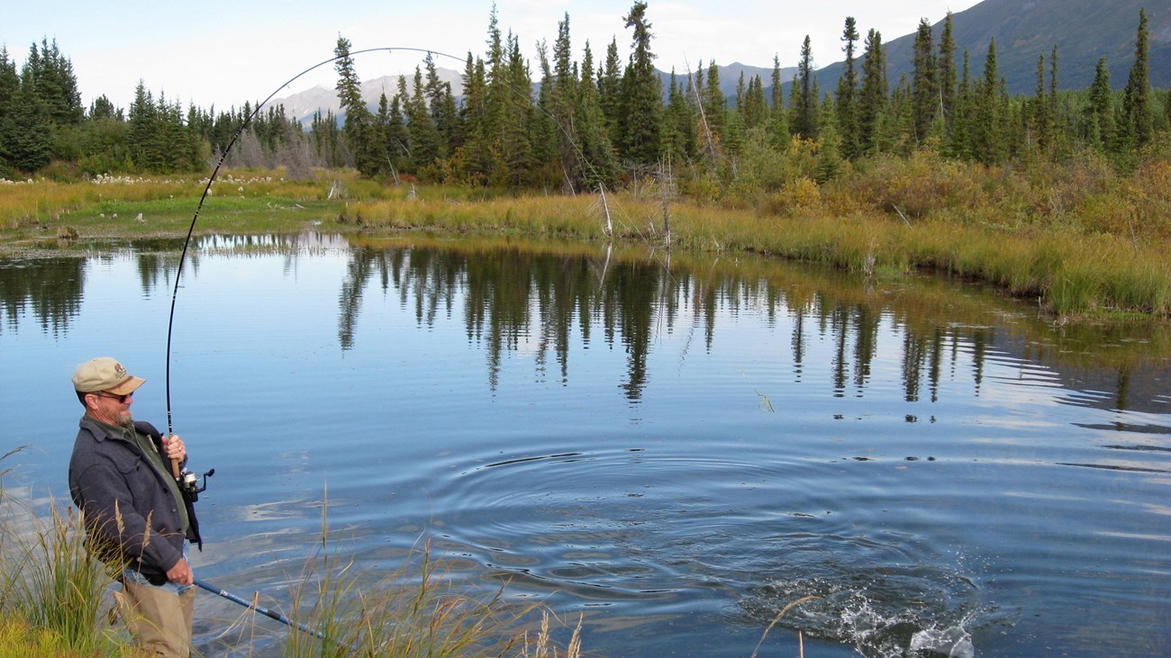 Person fishing at a lake